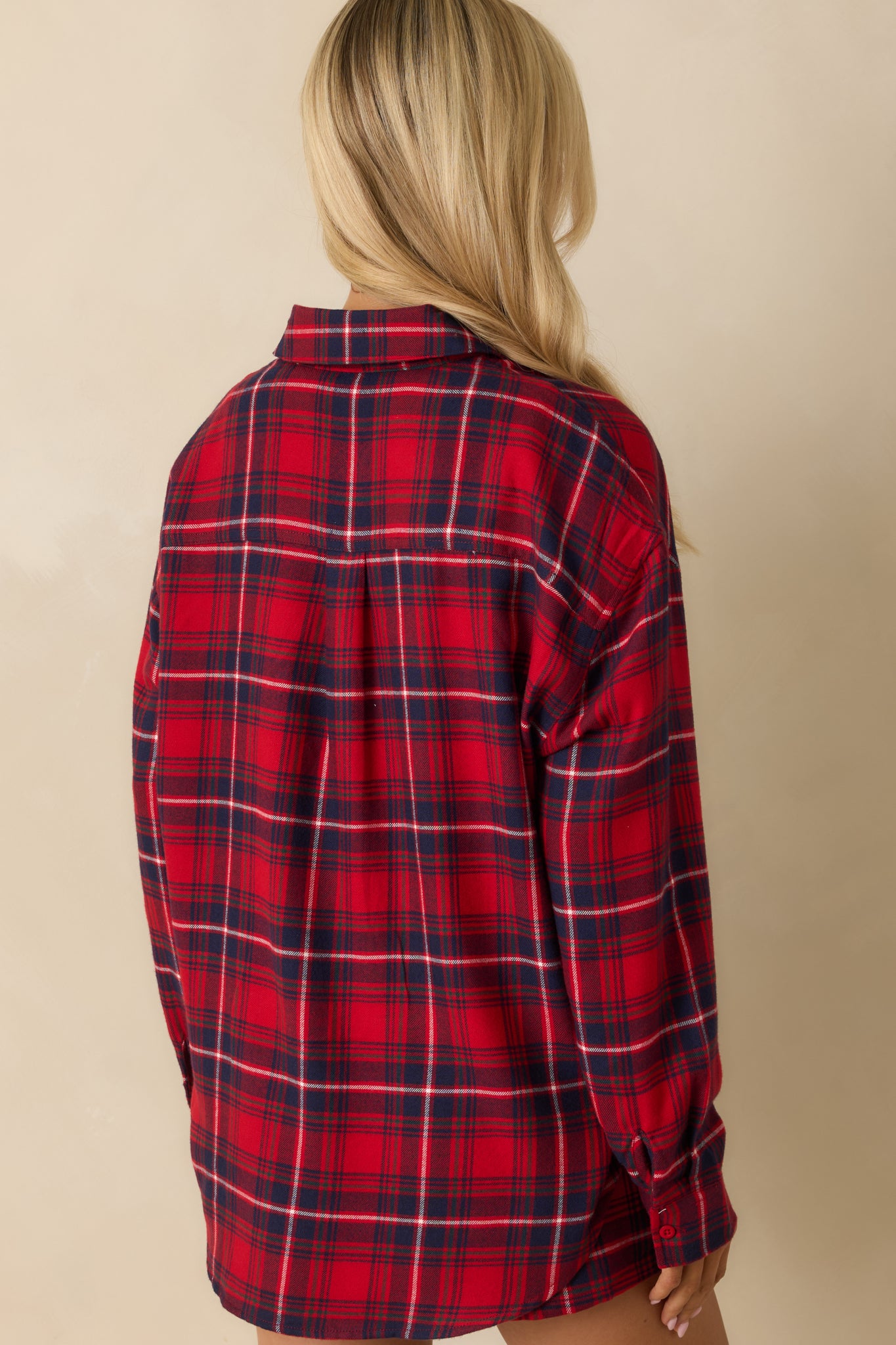 Rear view of red plaid button-up top, showing relaxed fit, long sleeves, and soft flannel fabric.