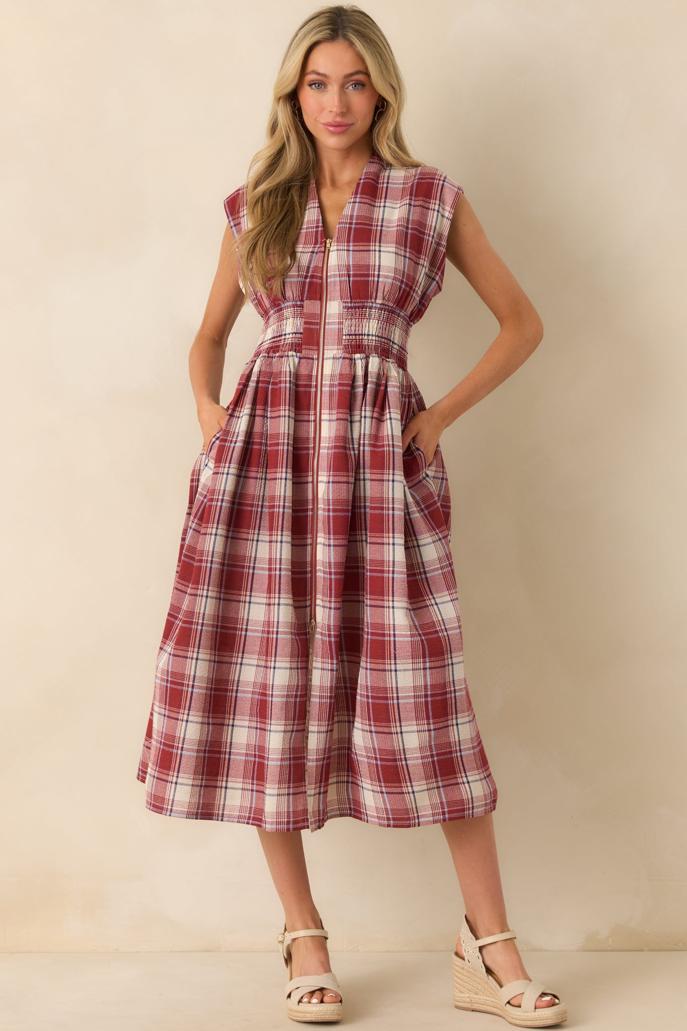 Red plaid midi dress featuring a full zipper front and structured silhouette.