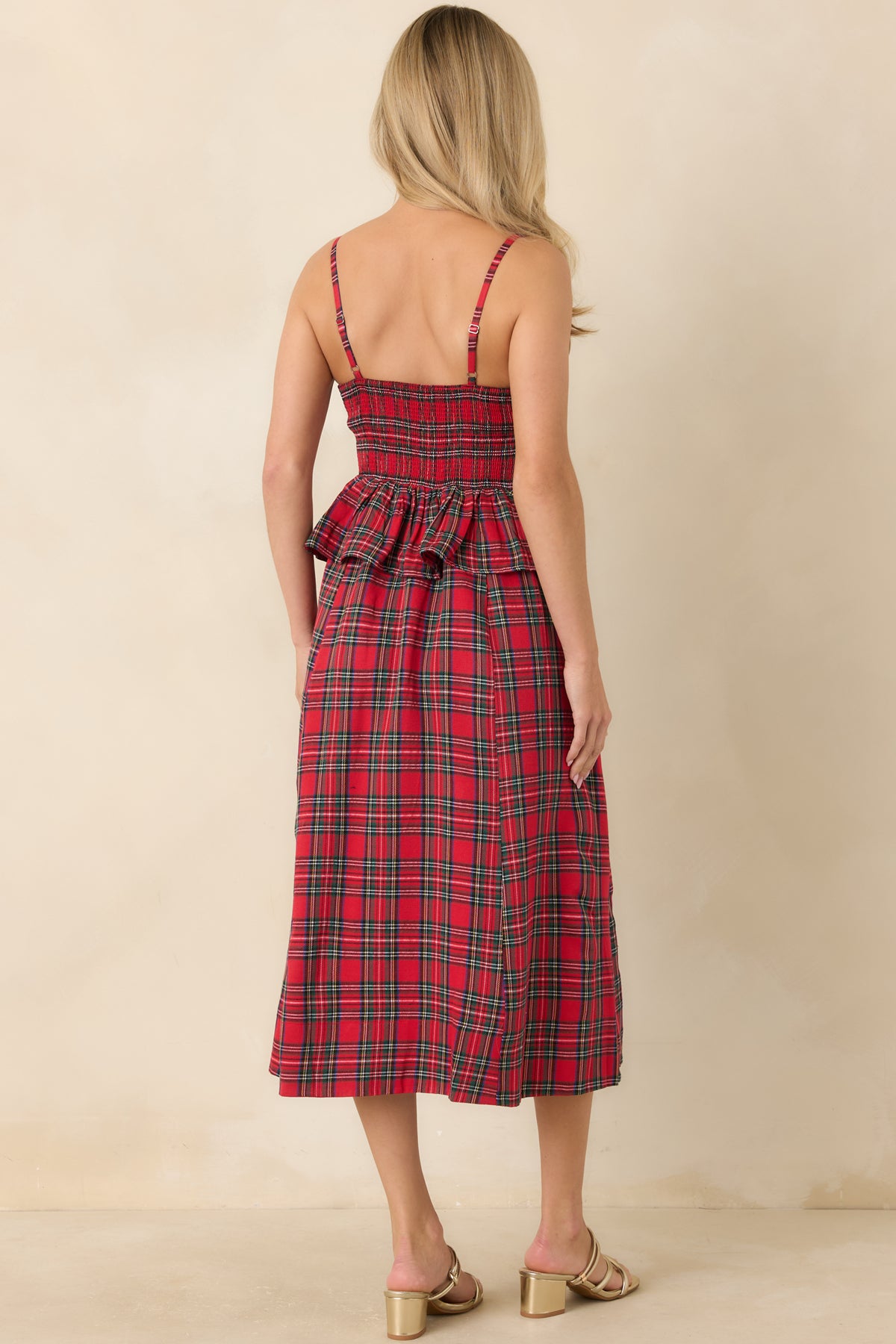 Rear view of the red plaid midi dress showing the smocked back panel and adjustable shoulder straps.