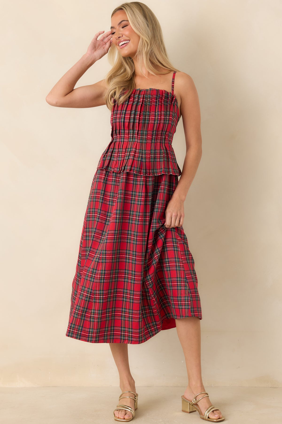 Red plaid midi dress with a ruffled neckline, pleated bodice, and flared skirt.