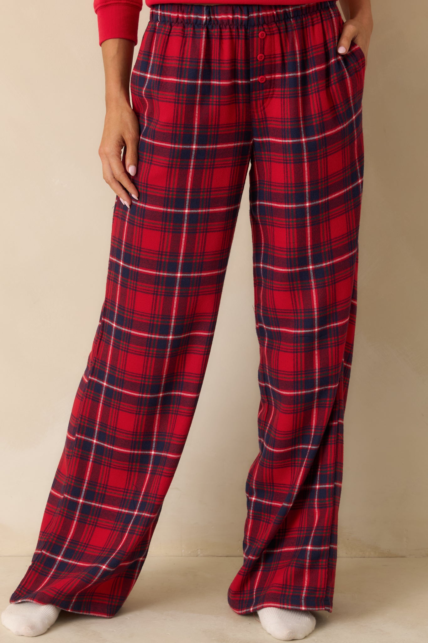 Red plaid straight-leg pajama pants in lightweight flannel with high-rise elastic waistband and relaxed fit.