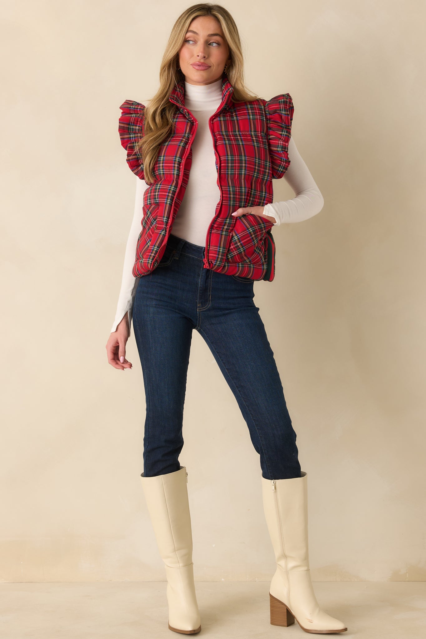Red plaid puffer vest showing its zip-front closure and high collar.