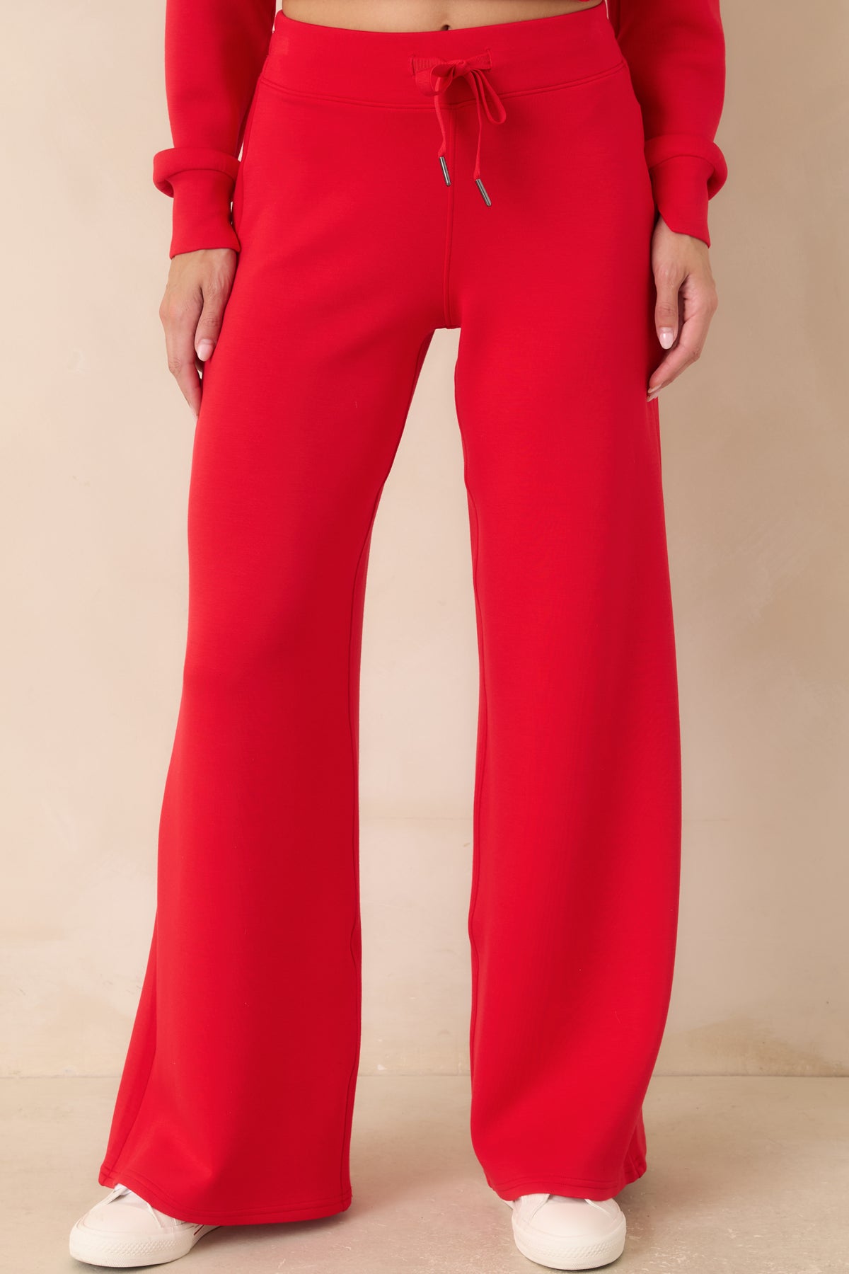 Red pull-on pants showcasing the streamlined waistband, flowing silhouette, and soft stretch fabric.
