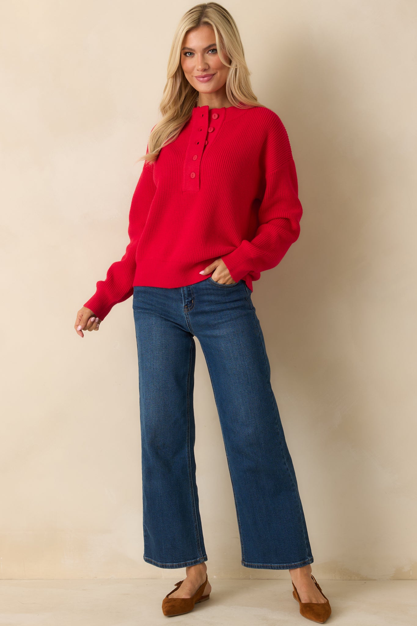 Cozy red pullover sweater in mid-weight knit with dropped shoulders and ribbed trim along the cuffs and hem.