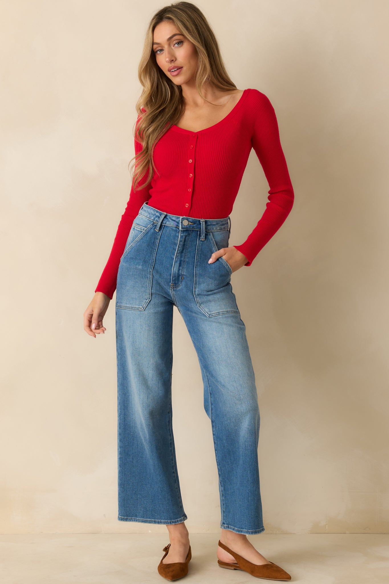 Red off-shoulder ribbed sweater in soft knit blend, showing fitted silhouette and long sleeves.