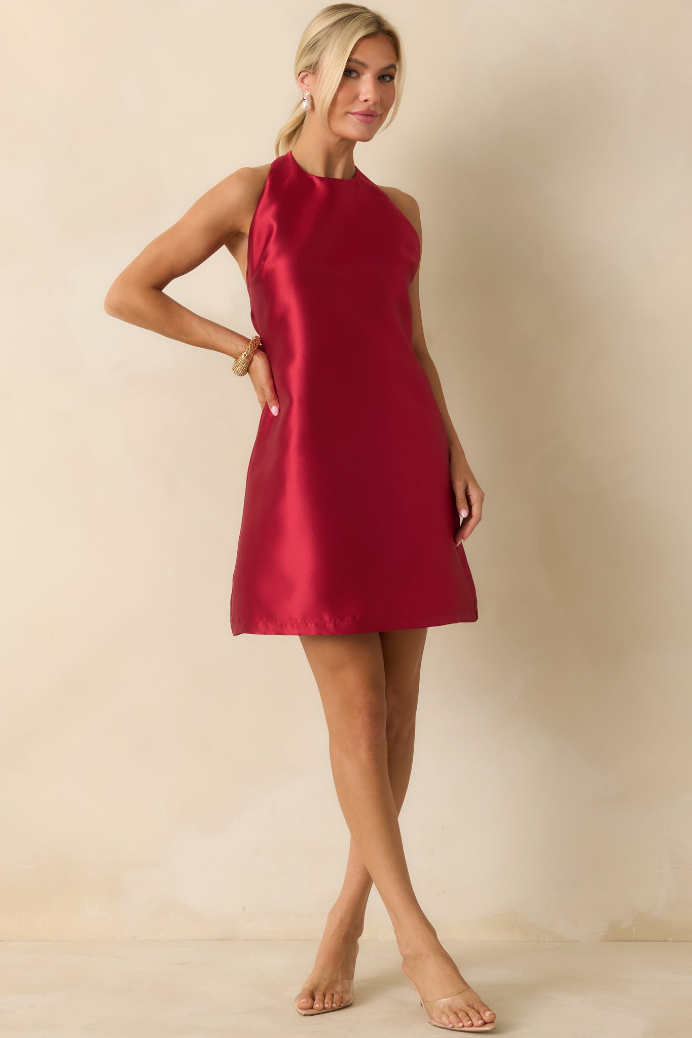 Red satin mini dress with a halter neckline and smooth A-line silhouette.