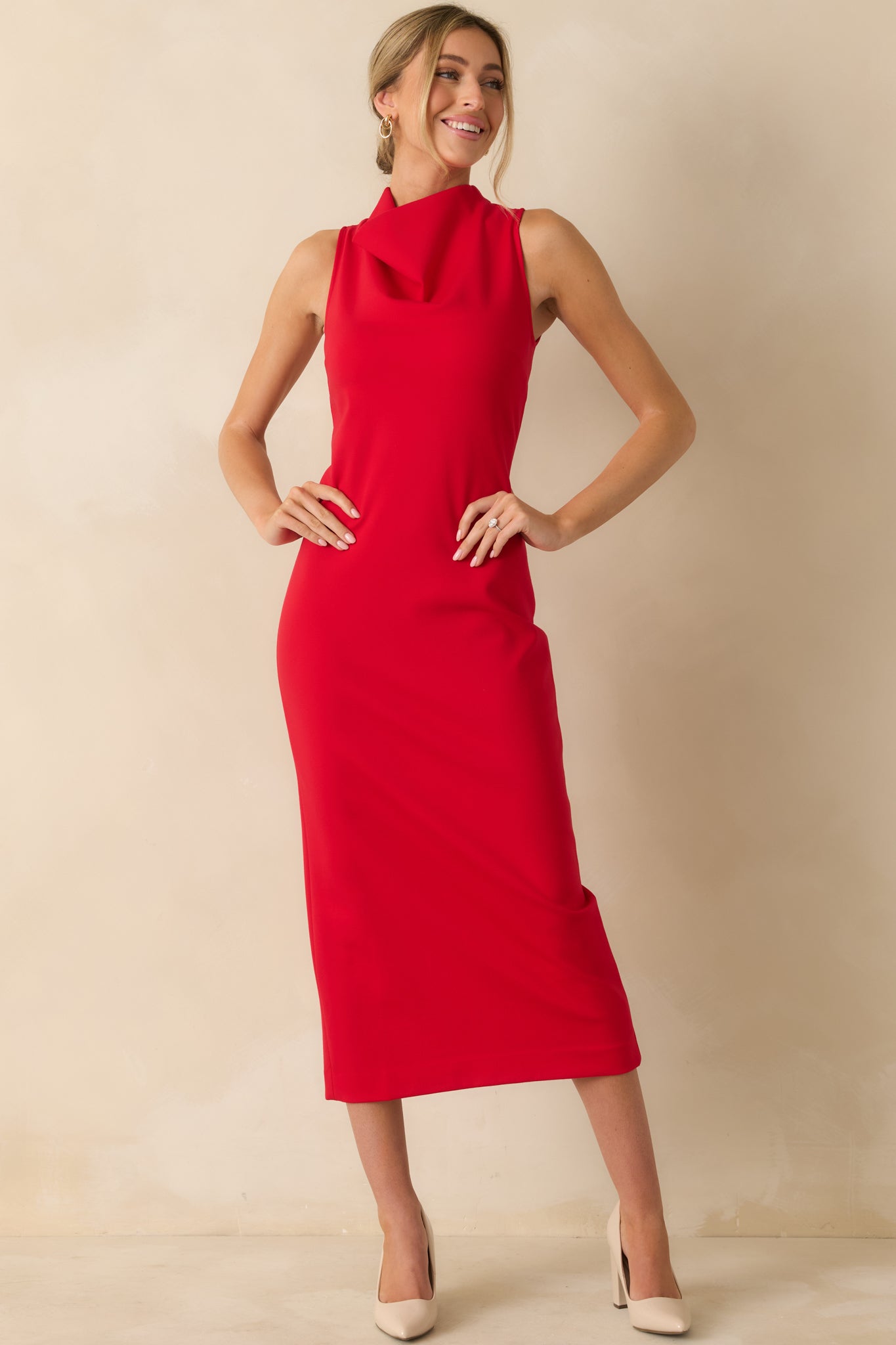 Red sleeveless midi dress with a sleek, bodycon fit, high neckline, and stretchy ponte fabric that contours the silhouette.