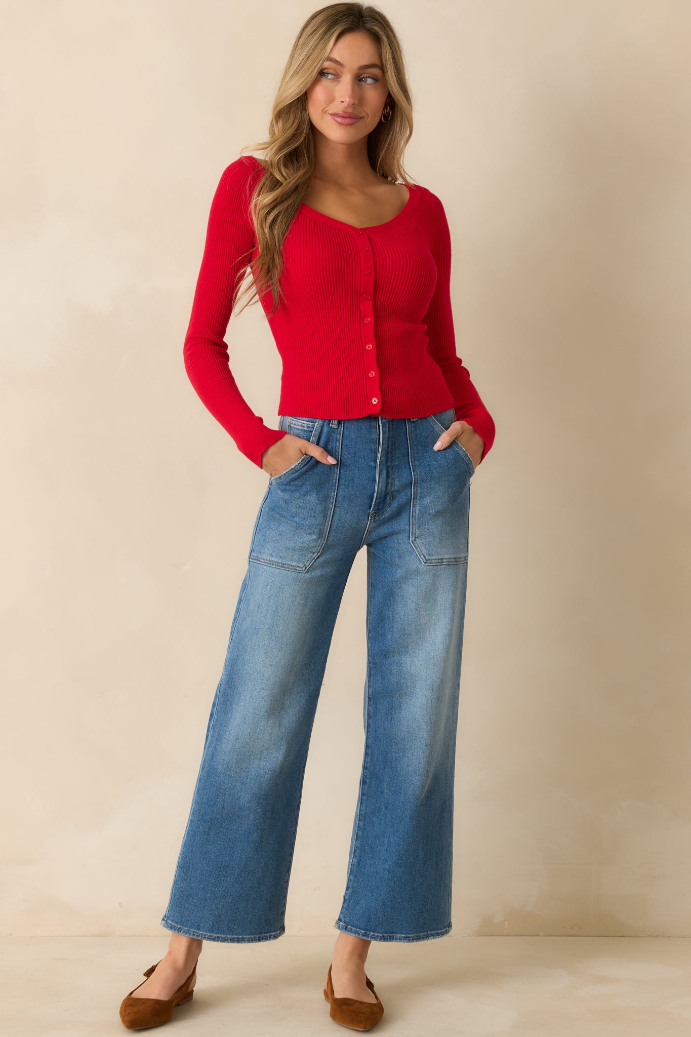 Red ribbed sweater with off-shoulder neckline, button-front closure, long sleeves, and fitted cropped silhouette.