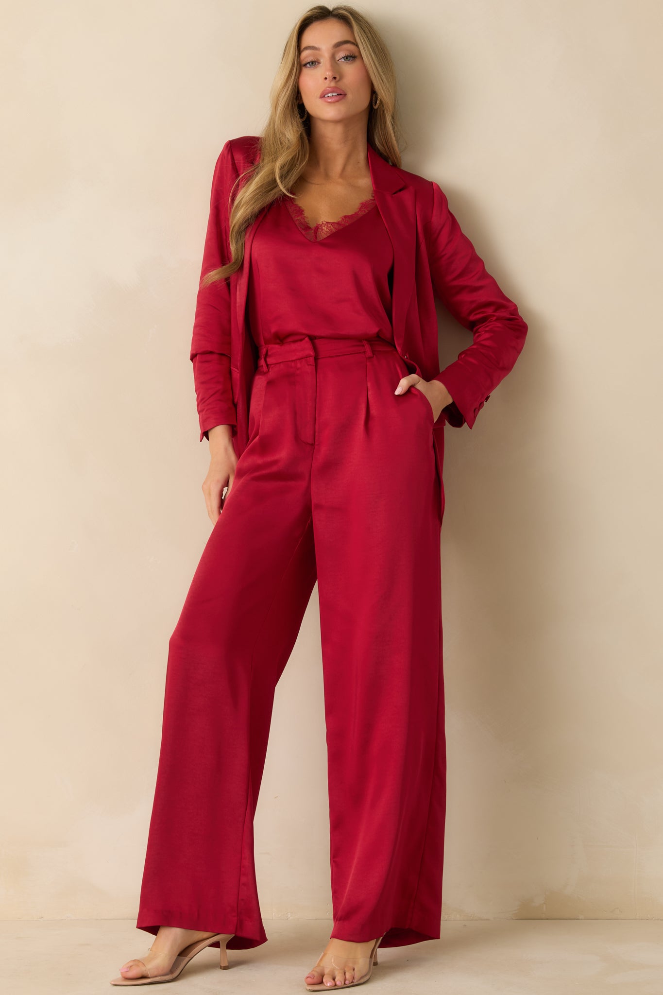 Polished red tailored blazer with a notched lapel, single-button closure, faux flap pockets, and long sleeves with buttoned cuffs.