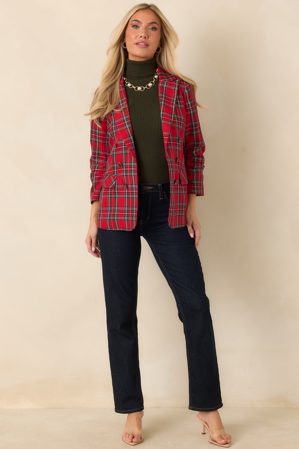 Red tartan blazer featuring functional flap pockets, notched lapels, and a structured front.