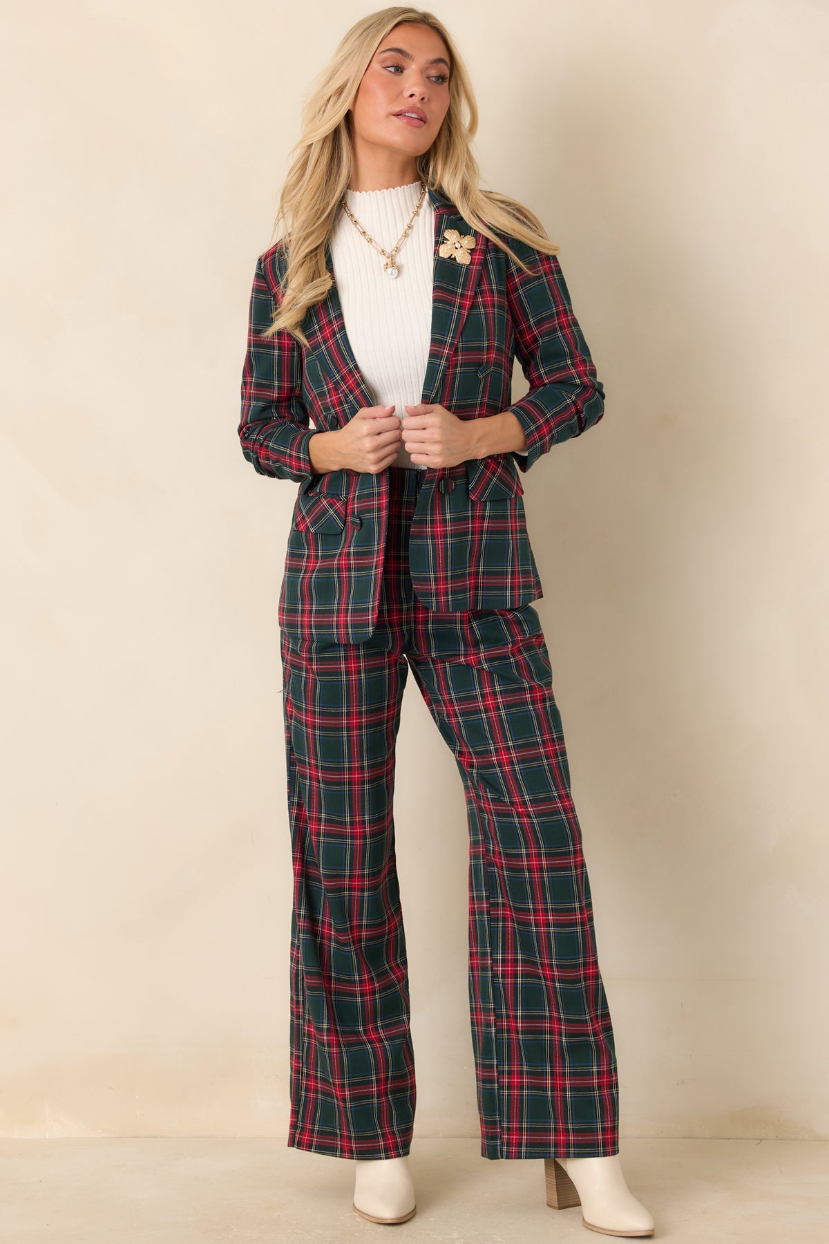 Tailored red tartan blazer featuring a button closure, gathered sleeve detailing, and a polished plaid pattern.