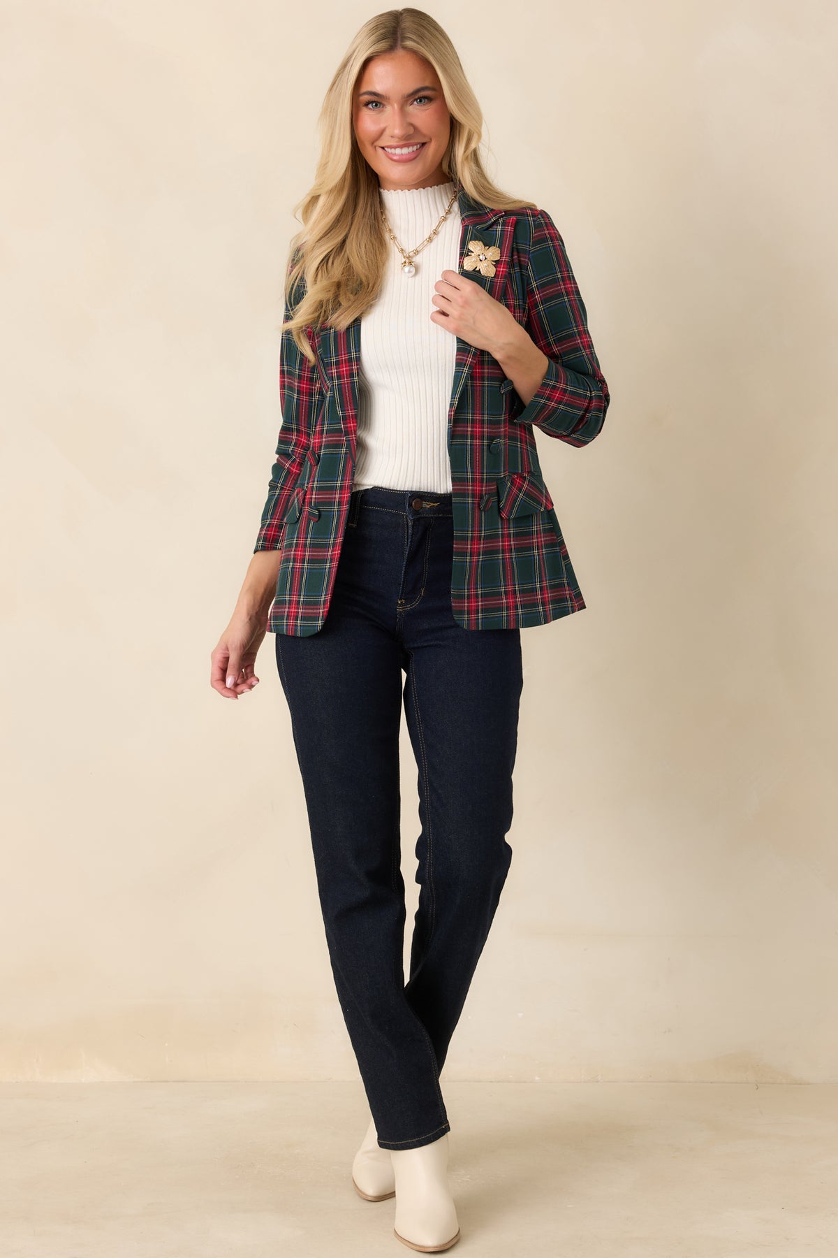 Red tartan blazer showcasing a structured shape, notched collar, and softly gathered sleeves.
