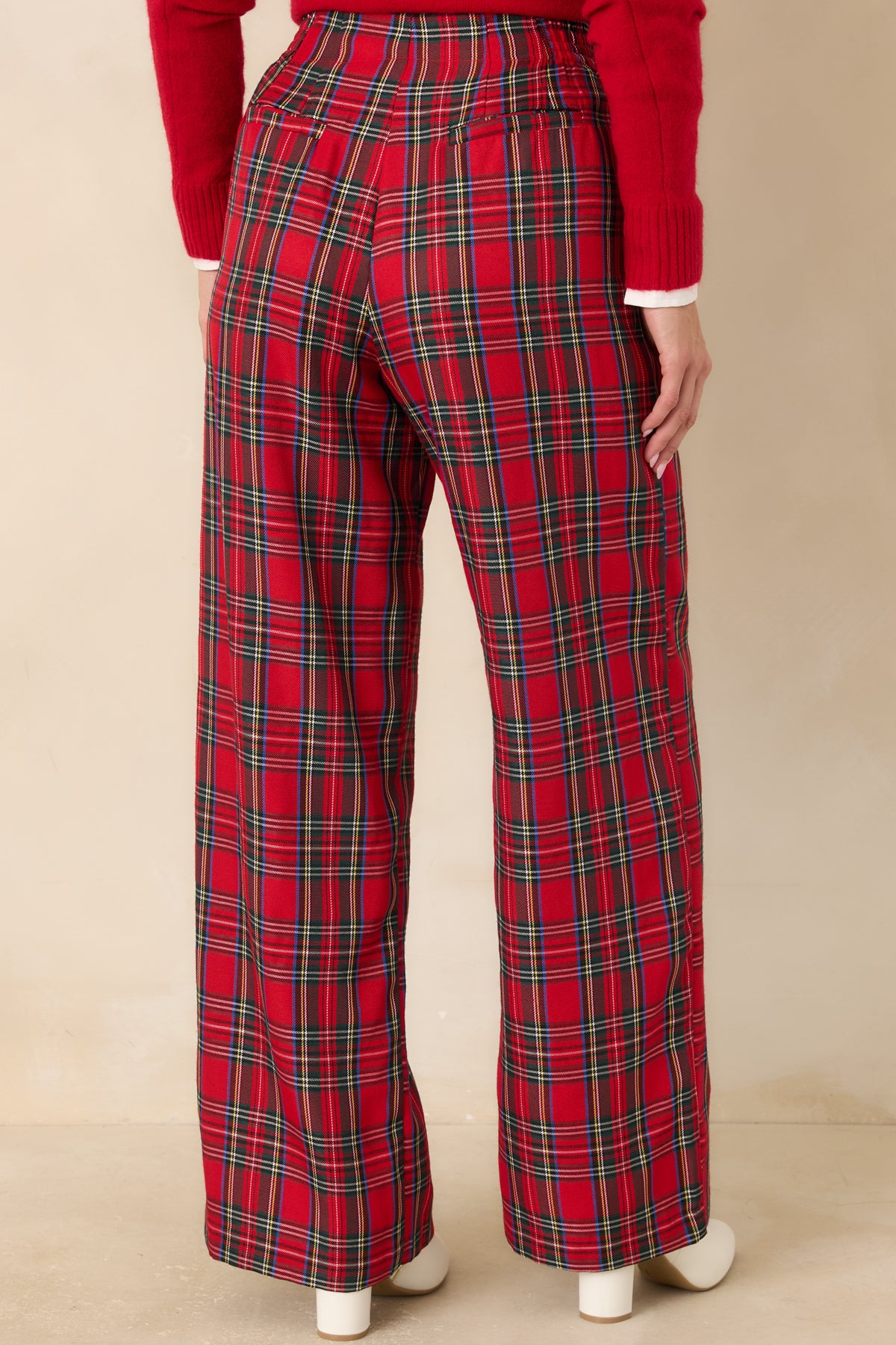 Rear view of the red tartan wide-leg pants with faux welt pockets and a tailored waistband.