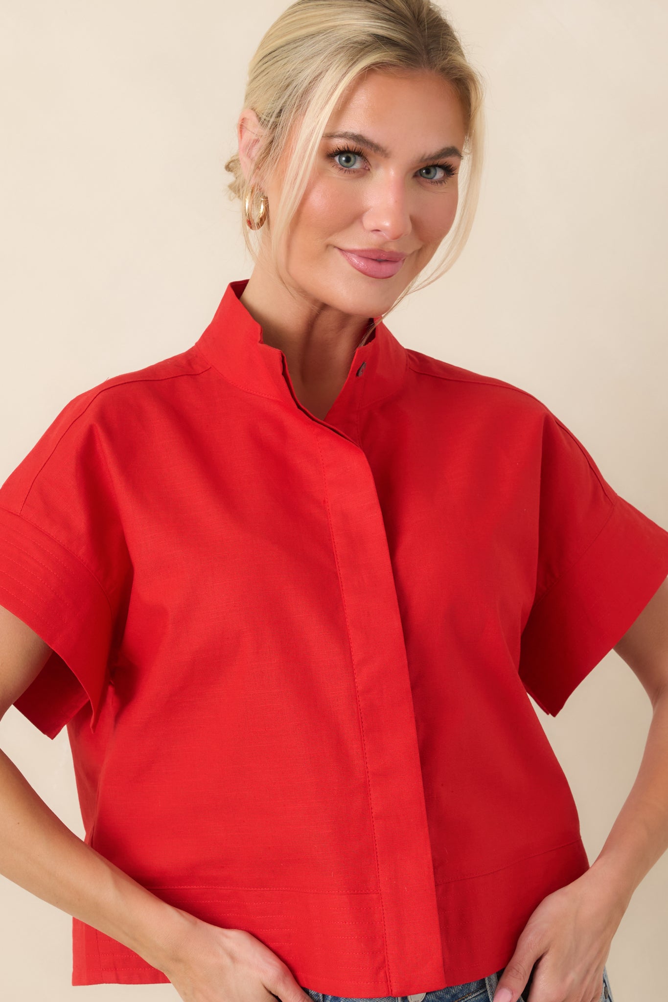 Red woven top highlighting boxy silhouette and breathable, lightweight fabric texture.