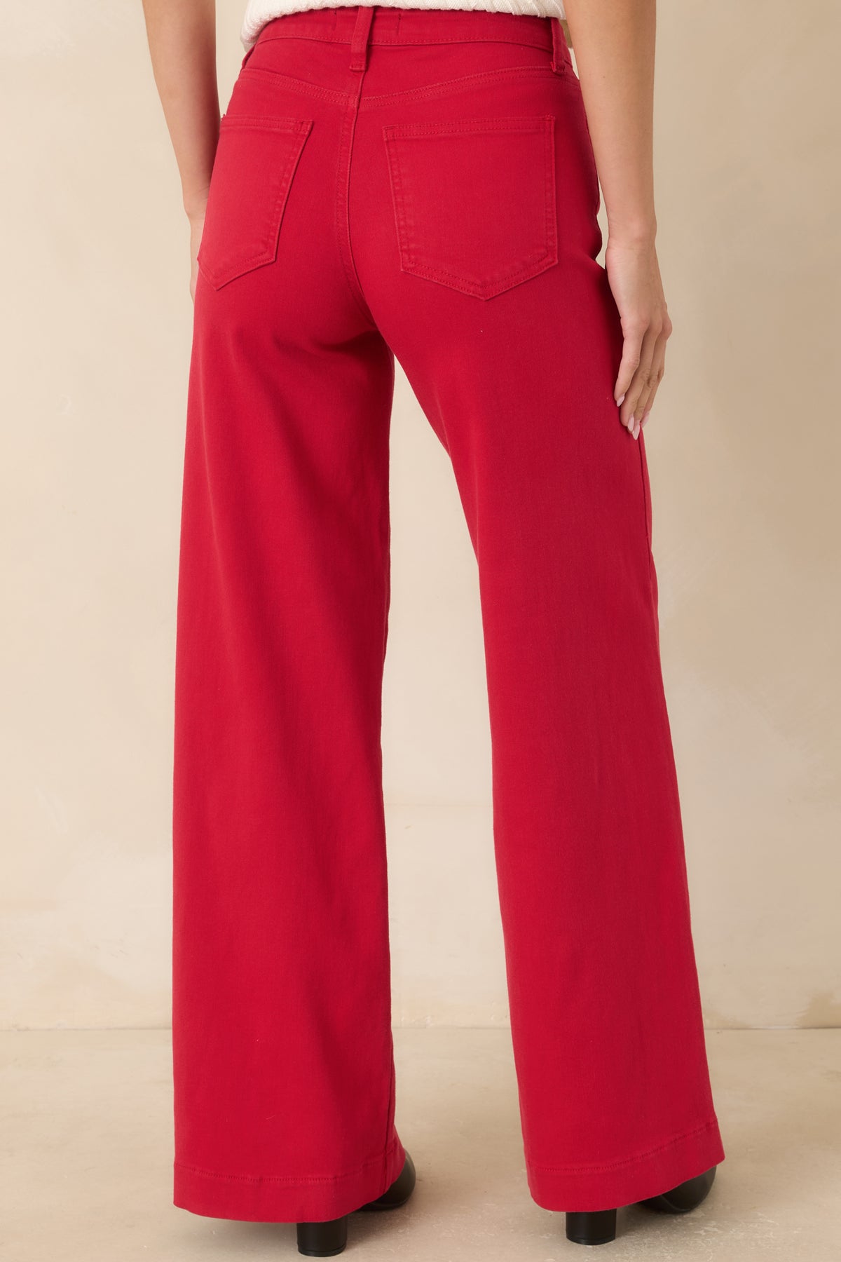 Rear view of the red wide leg jeans featuring traditional back pockets, high-rise fit, full-length legs, and clean seam detailing.