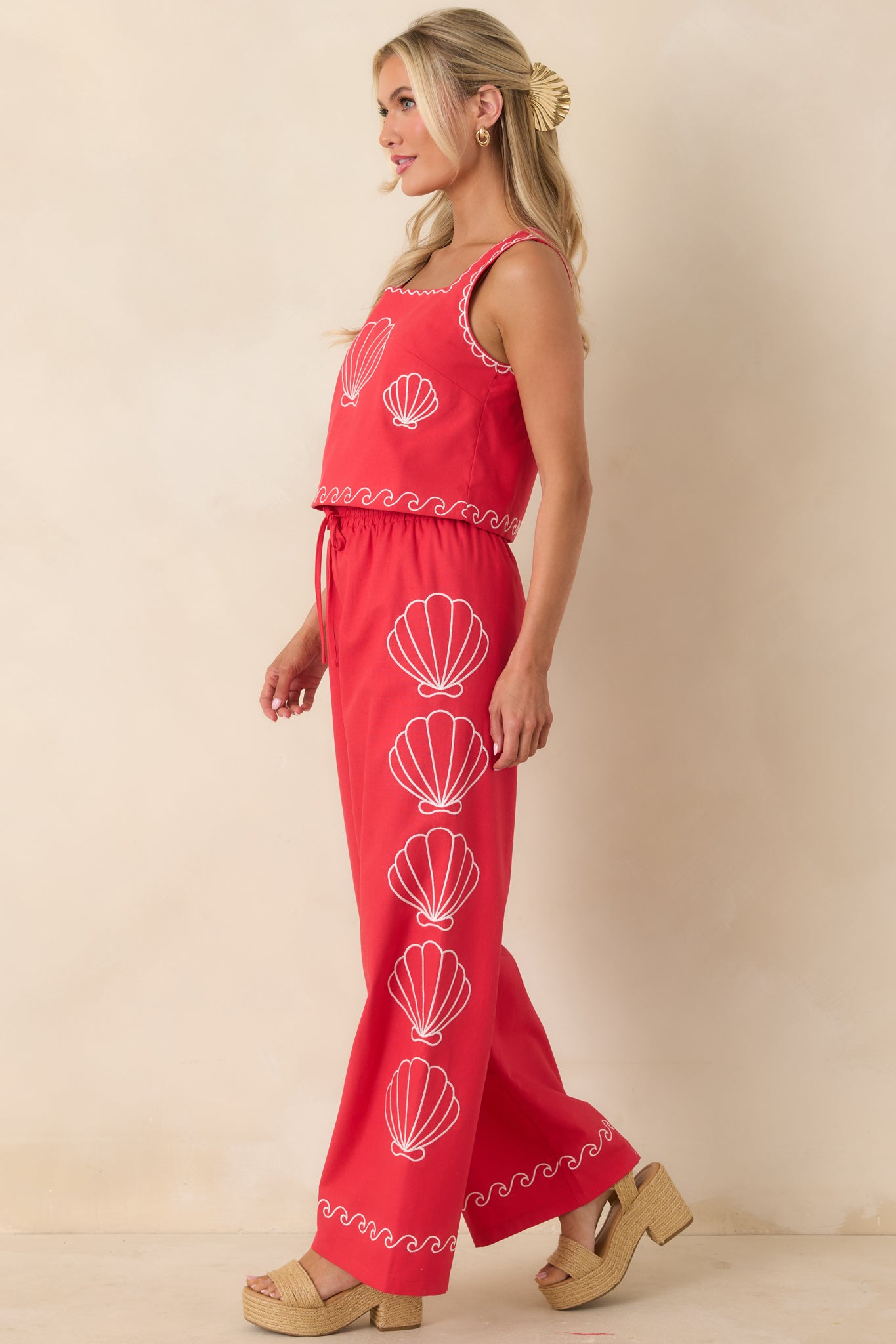 Red wide leg pants with elastic waistband and relaxed flowing silhouette.