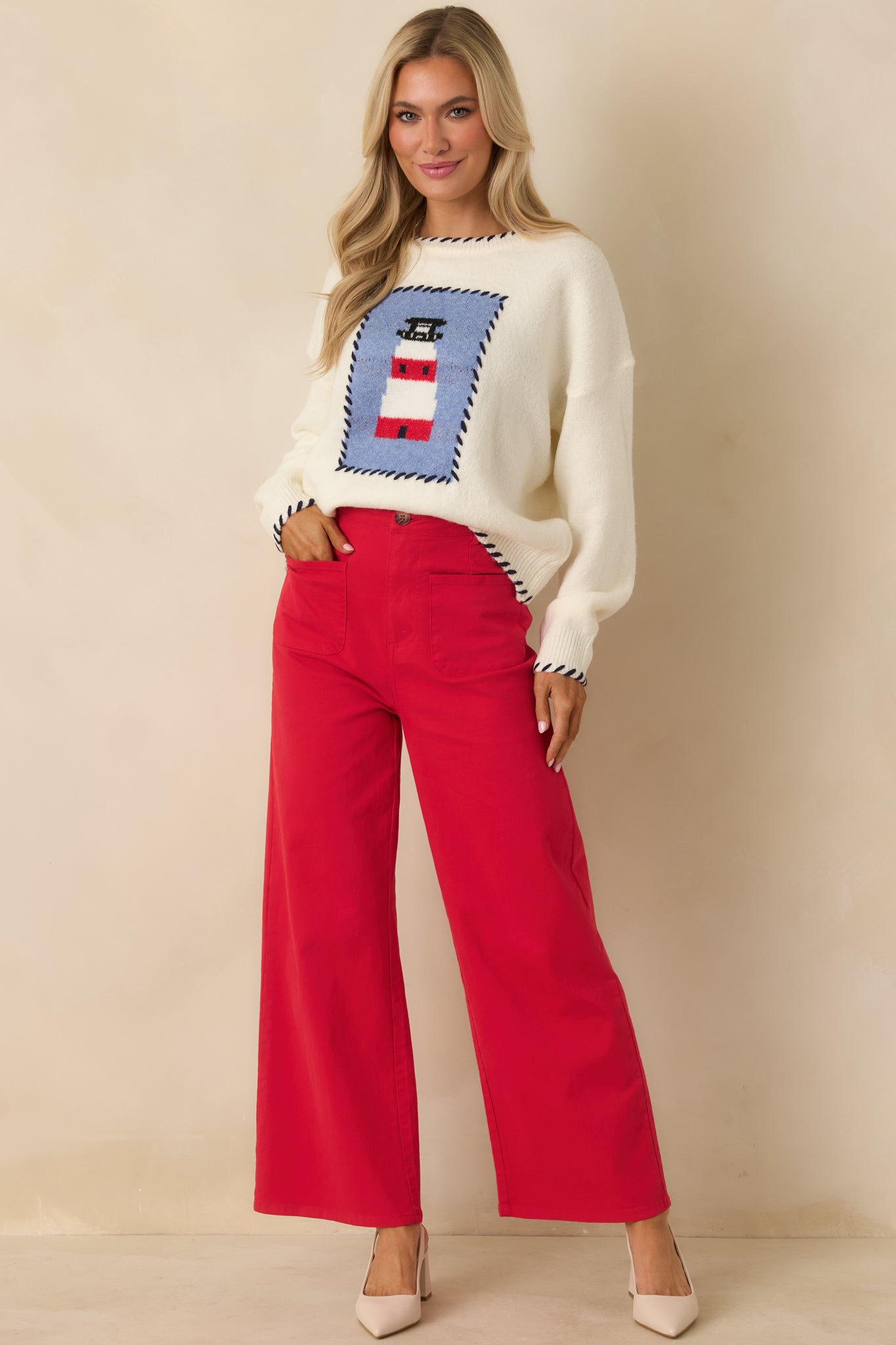 Red wide-leg pants with tortoise shell button closure and front zipper, full body front view.