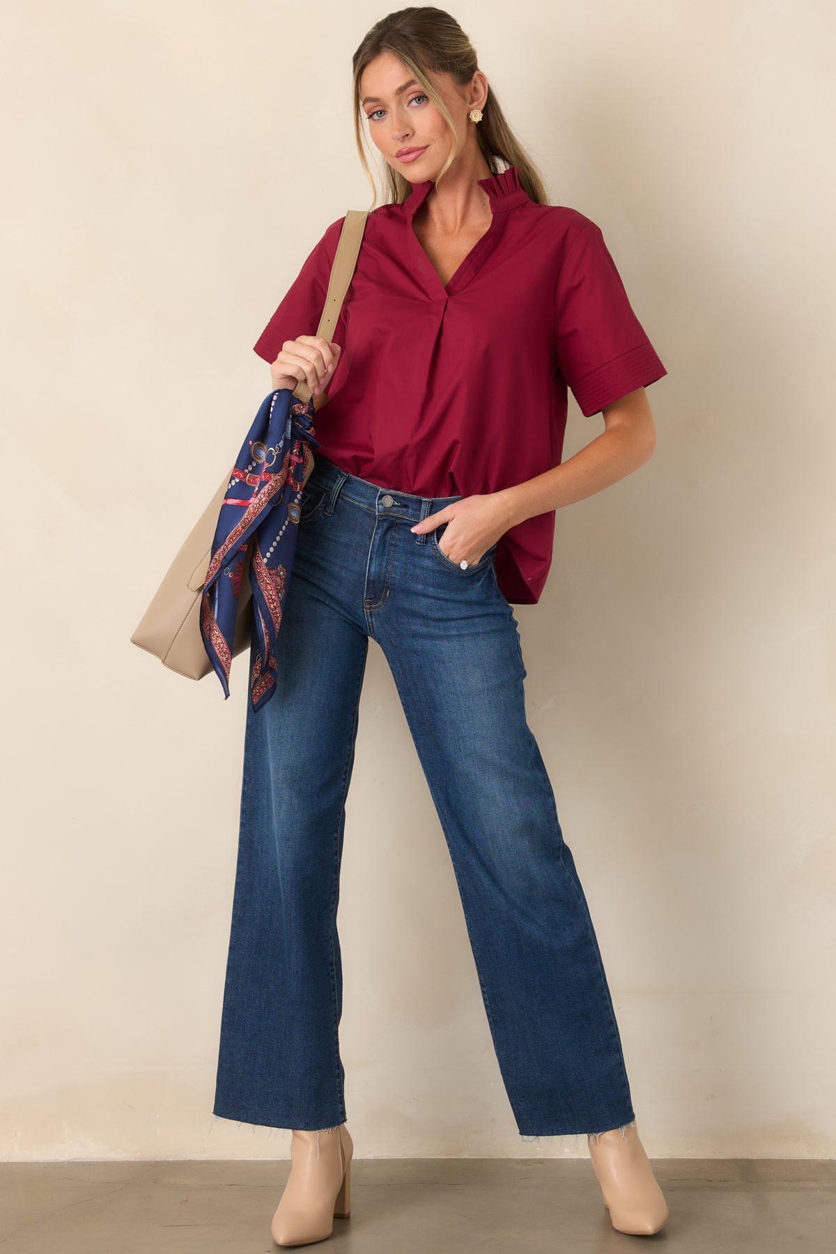 Refined cotton blouse featuring a feminine ruffled neckline, easy split-neck opening, short sleeves, and a graceful draped fit.