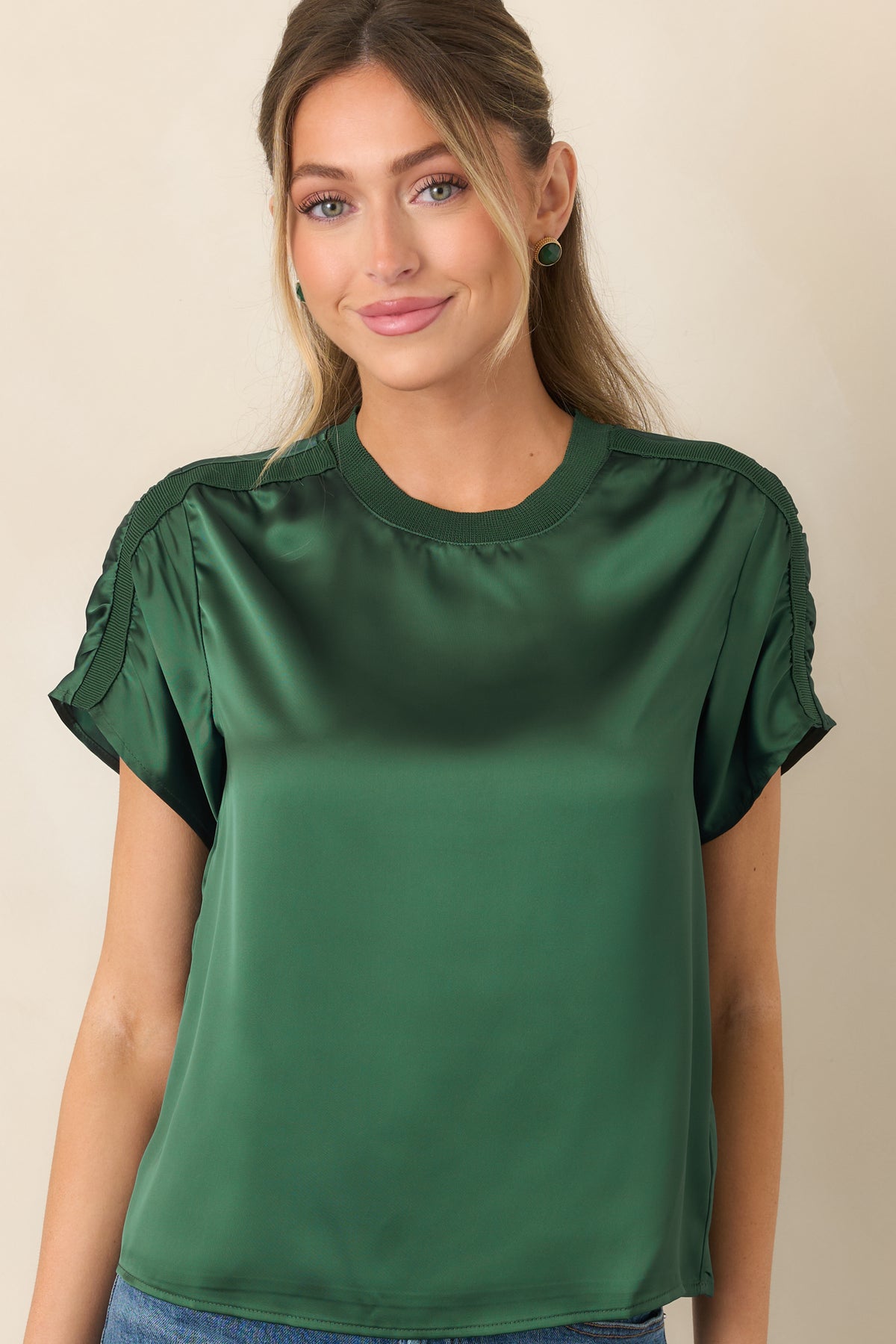 Refined satin top with delicate ribbed edging along the round neckline and shoulders for a modern athletic-inspired finish.