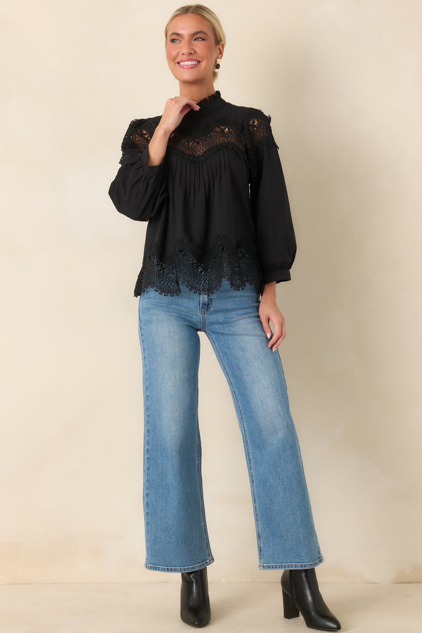 Relaxed black blouse with soft pintuck detailing, lace accents, and a gently voluminous silhouette.