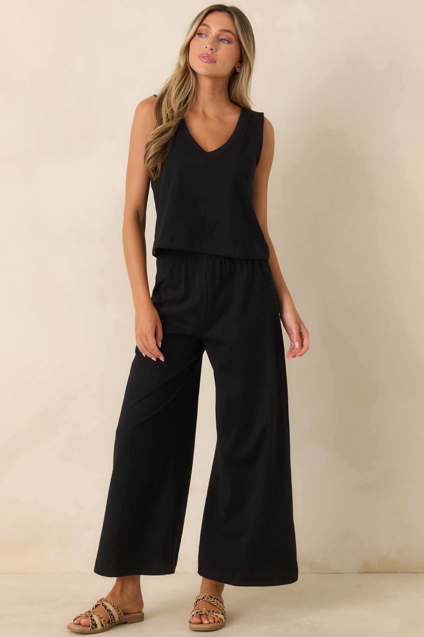 Relaxed black pants crafted with soft jersey fabric, an elastic waistband, and comfortable silhouette.