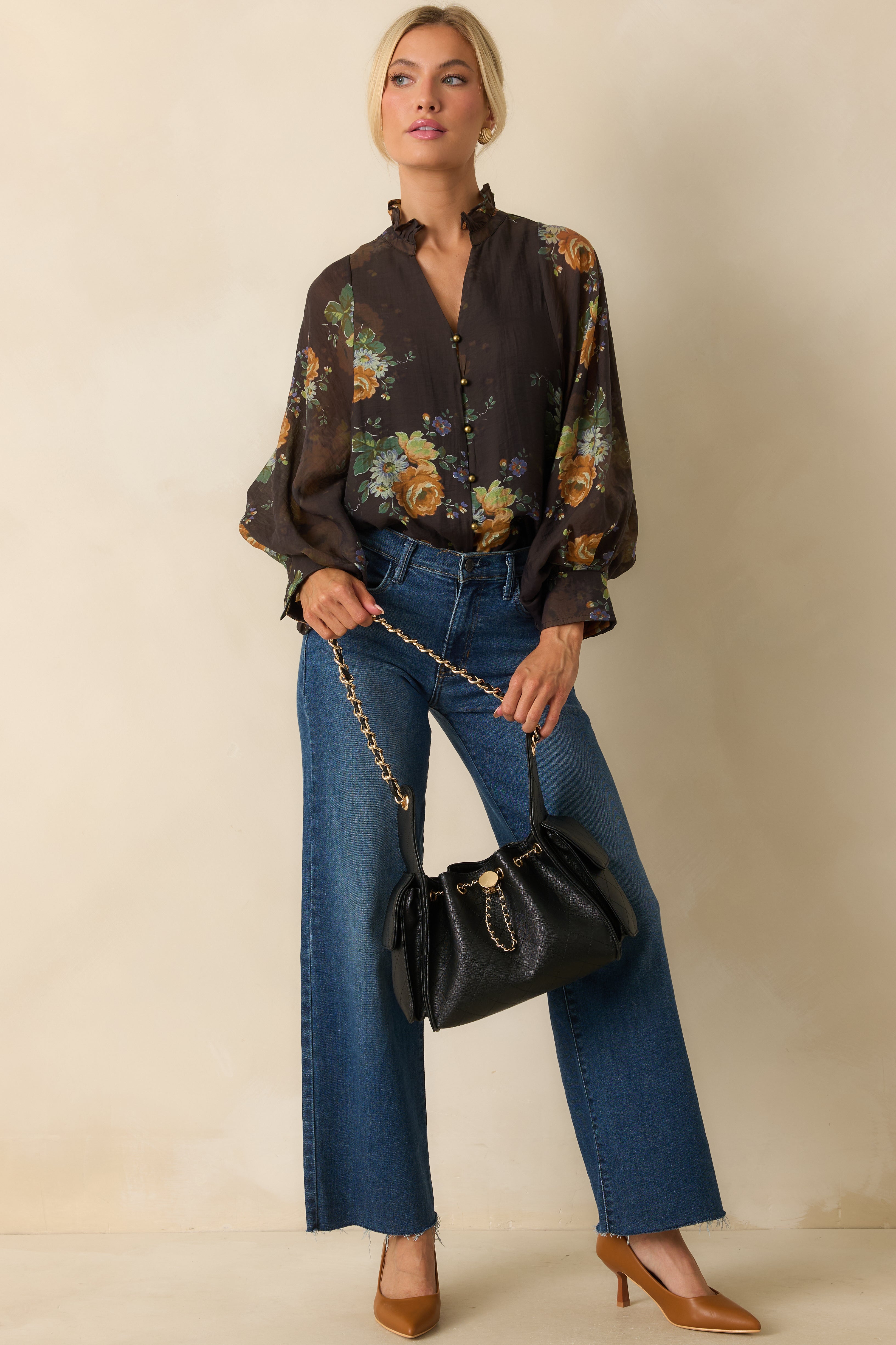 Relaxed-fit blouse featuring front gold button closure and flowy silhouette.