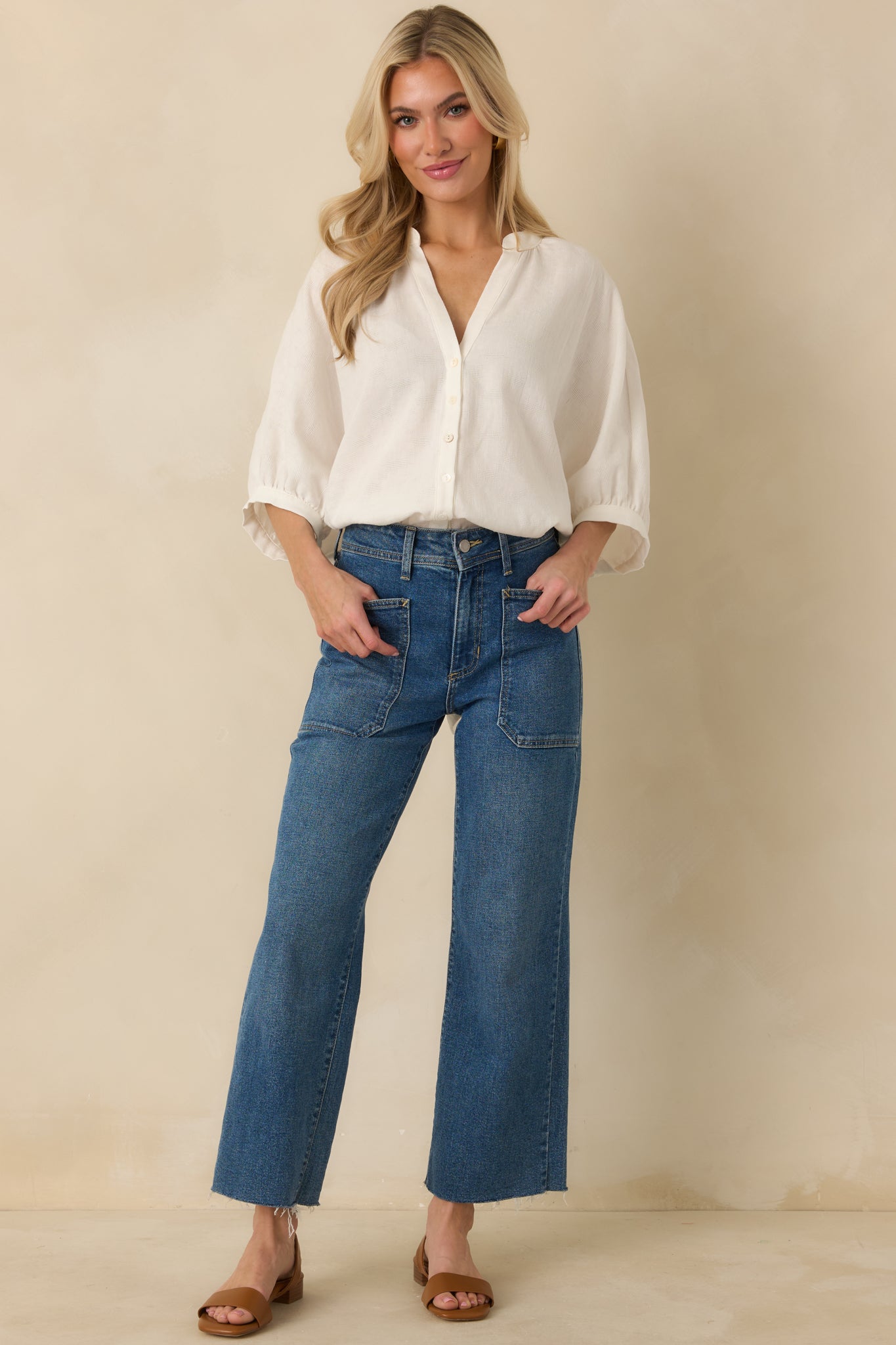 Relaxed fit blouse with split neckline, front button closure, and softly gathered 3/4 length sleeves with elastic cuffs.