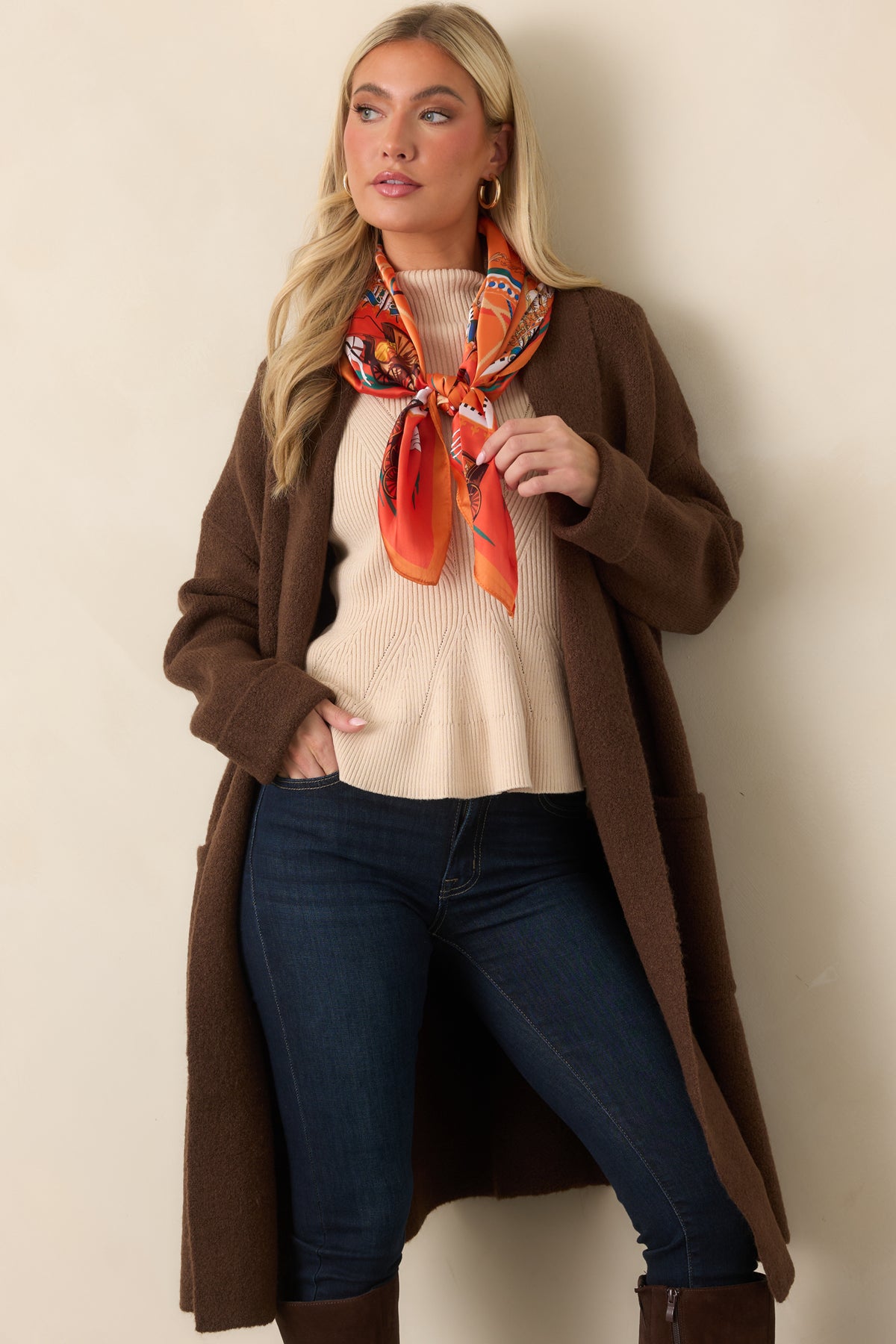 Relaxed chocolate brown cardigan featuring an open front, roomy patch pockets, and long sleeves with turned-back cuffs.