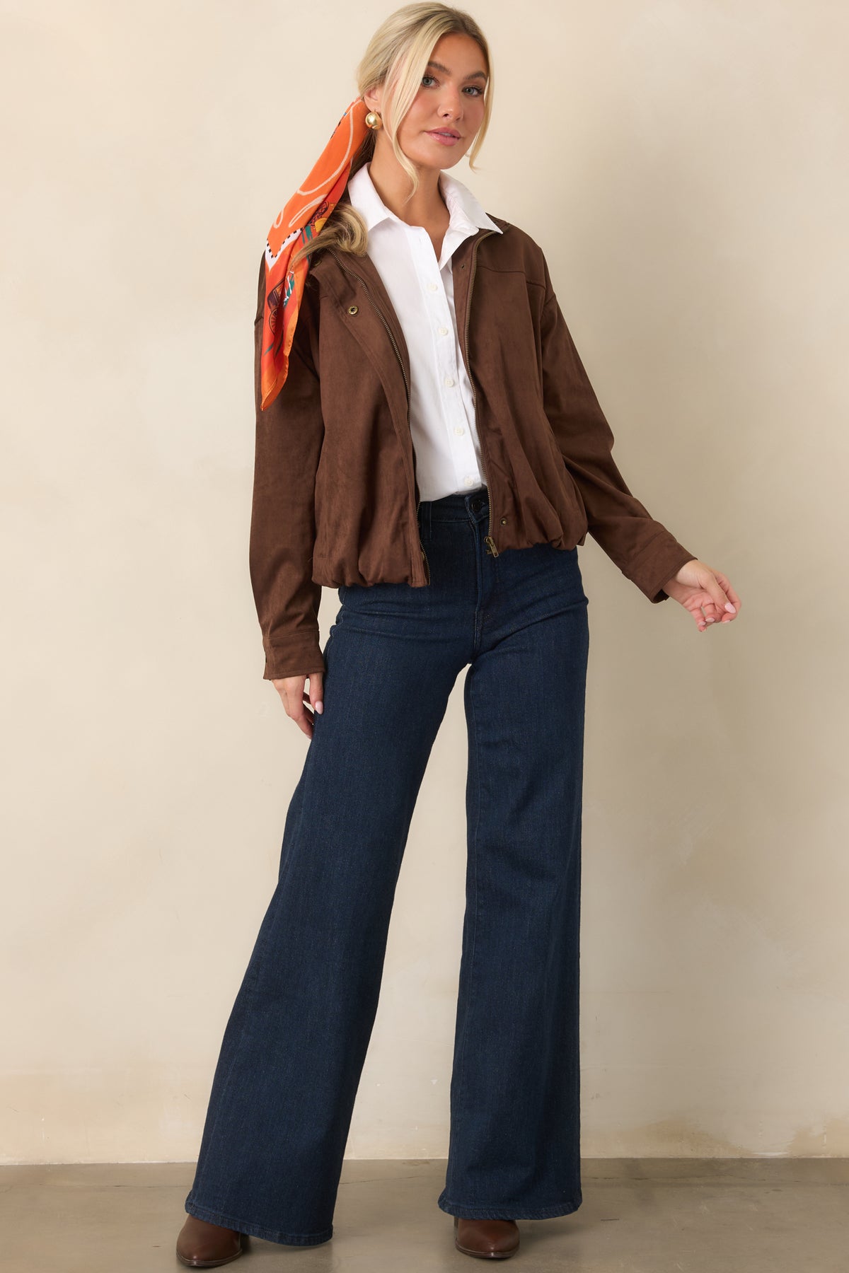 Relaxed chocolate brown bomber with a snap-front placket, elasticized hem, and full lining.