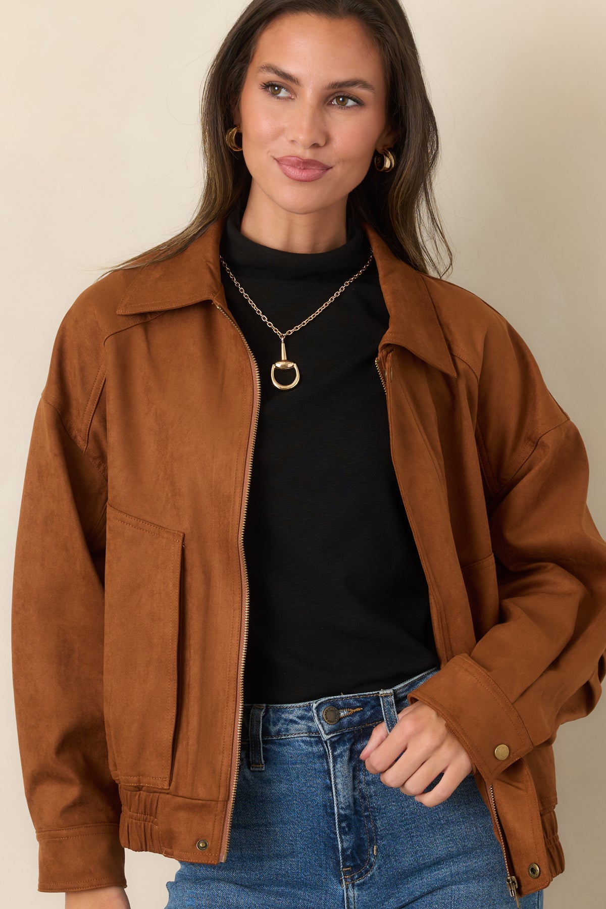 Relaxed cognac bomber jacket featuring a pointed collar, front pockets, and clean zip closure.