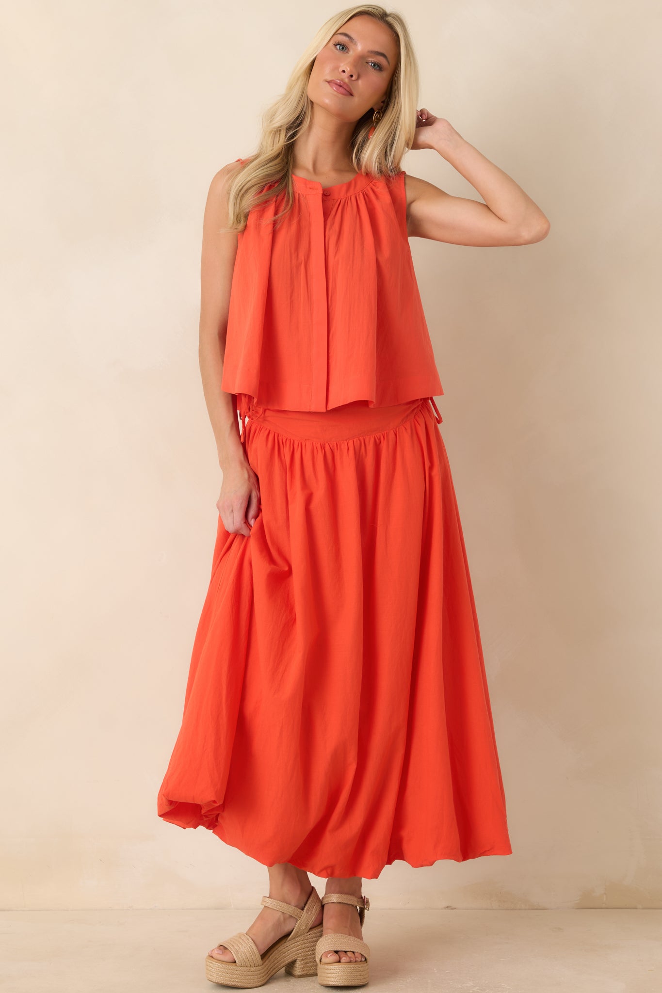 Relaxed coral orange cotton top featuring a flared silhouette, crew neckline with soft gathers, and a lightweight breathable finish.