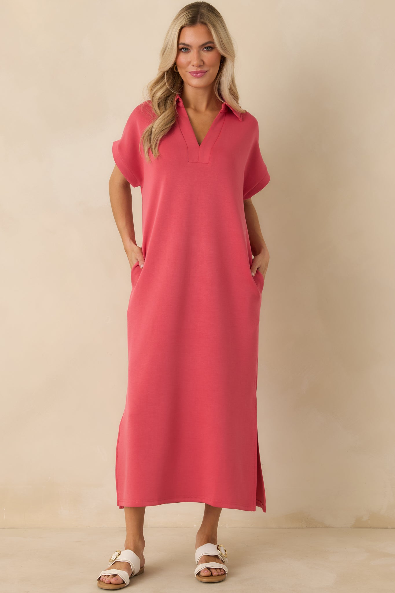 Relaxed-fit coral pink midi dress showcasing a clean collared neckline and subtle side leg vents.