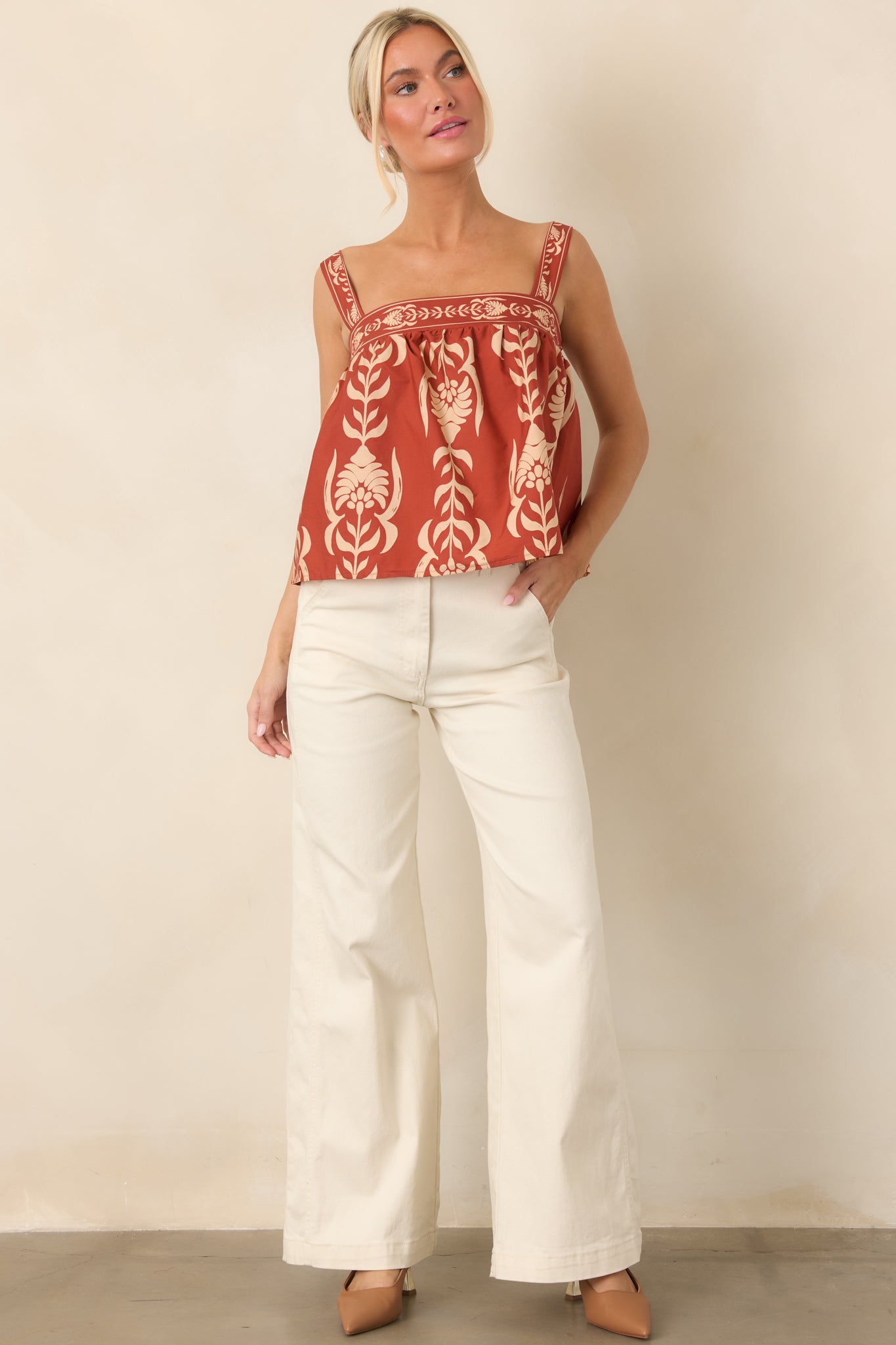 Relaxed 100% cotton top designed with wide straps, a square neckline, and an airy gathered silhouette.