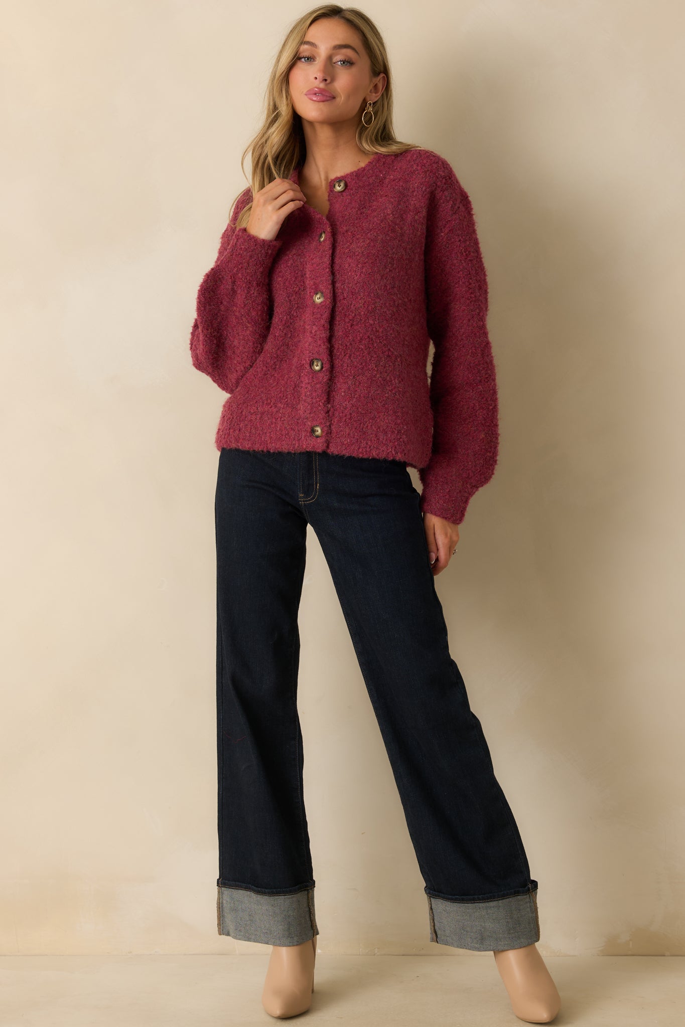 Relaxed cranberry button-front cardigan displayed to show its full-length drape and warm knit finish.