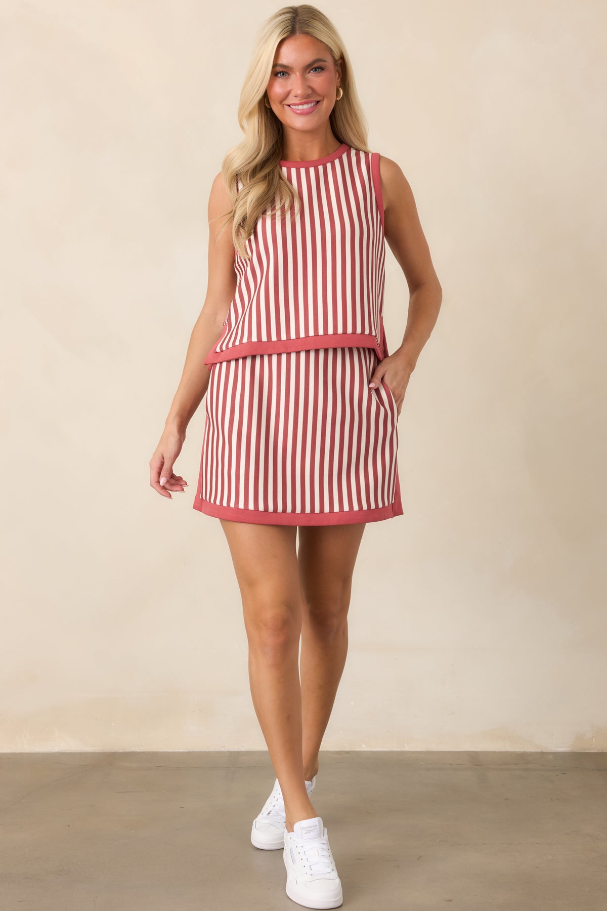 Relaxed cropped top showcasing its sleeveless cut, clean round collar, ivory and terracotta stripe pattern, and contrasting trim.