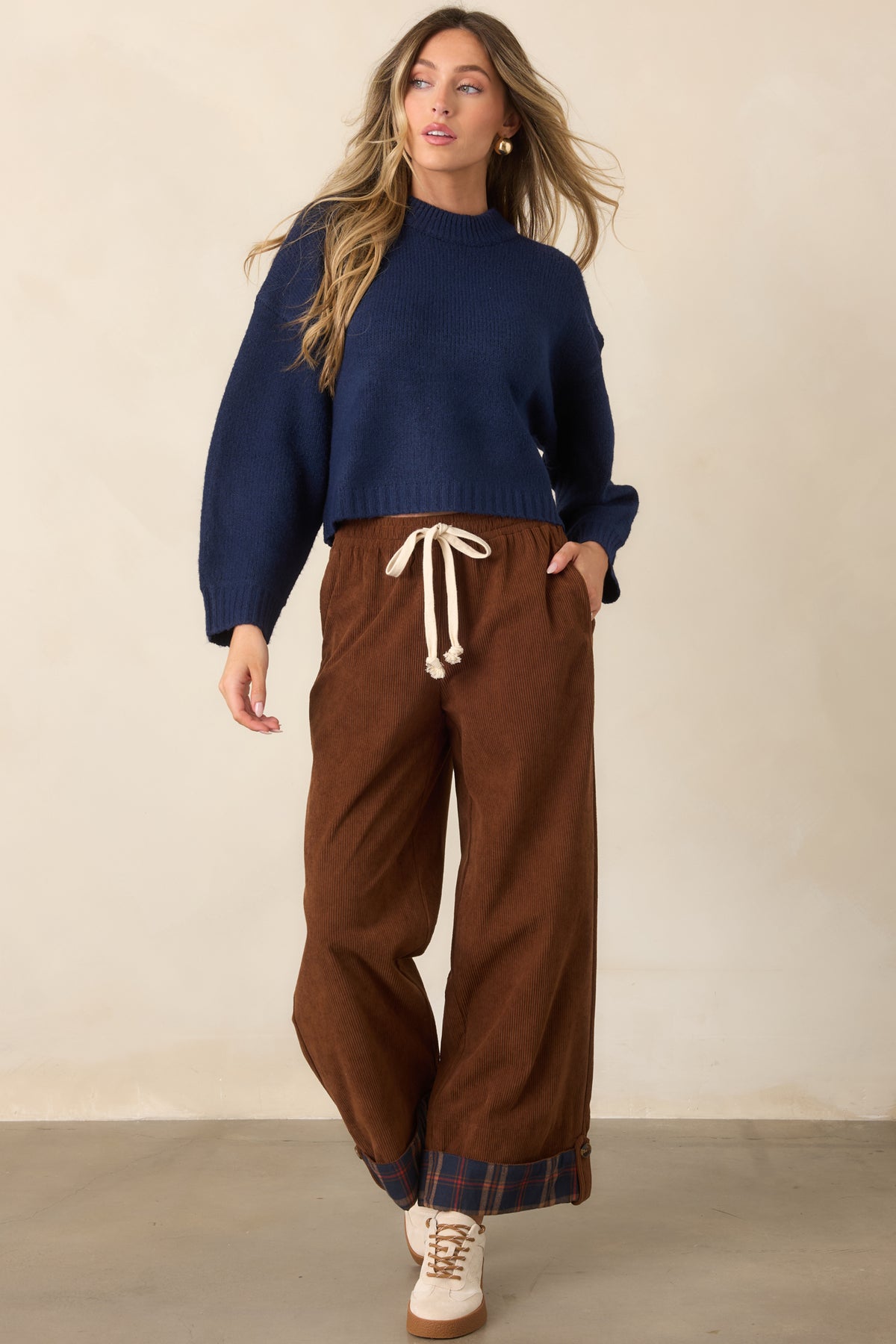 Relaxed deep navy pullover featuring a round ribbed neckline, dropped shoulders, long sleeves, and a classic ribbed hem.