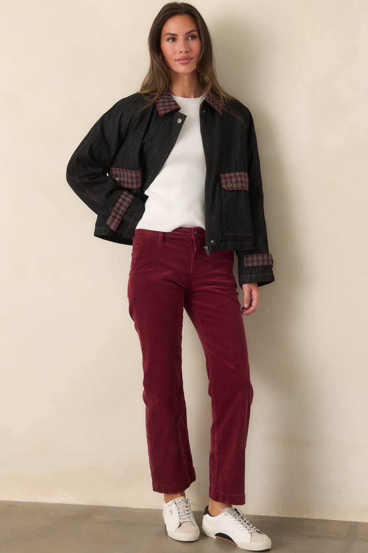 Relaxed denim jacket highlighting the contrasting gingham accents, roomy front pockets, raglan sleeves, and warm quilted interior.