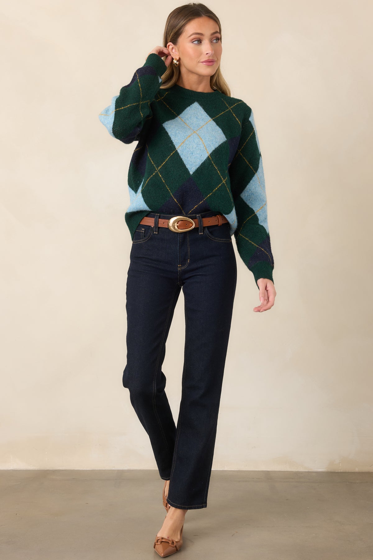 Relaxed sweater showcasing geometric diamond accents, golden yellow detailing, long sleeves, and ribbed trim along the neckline, cuffs, and hem.