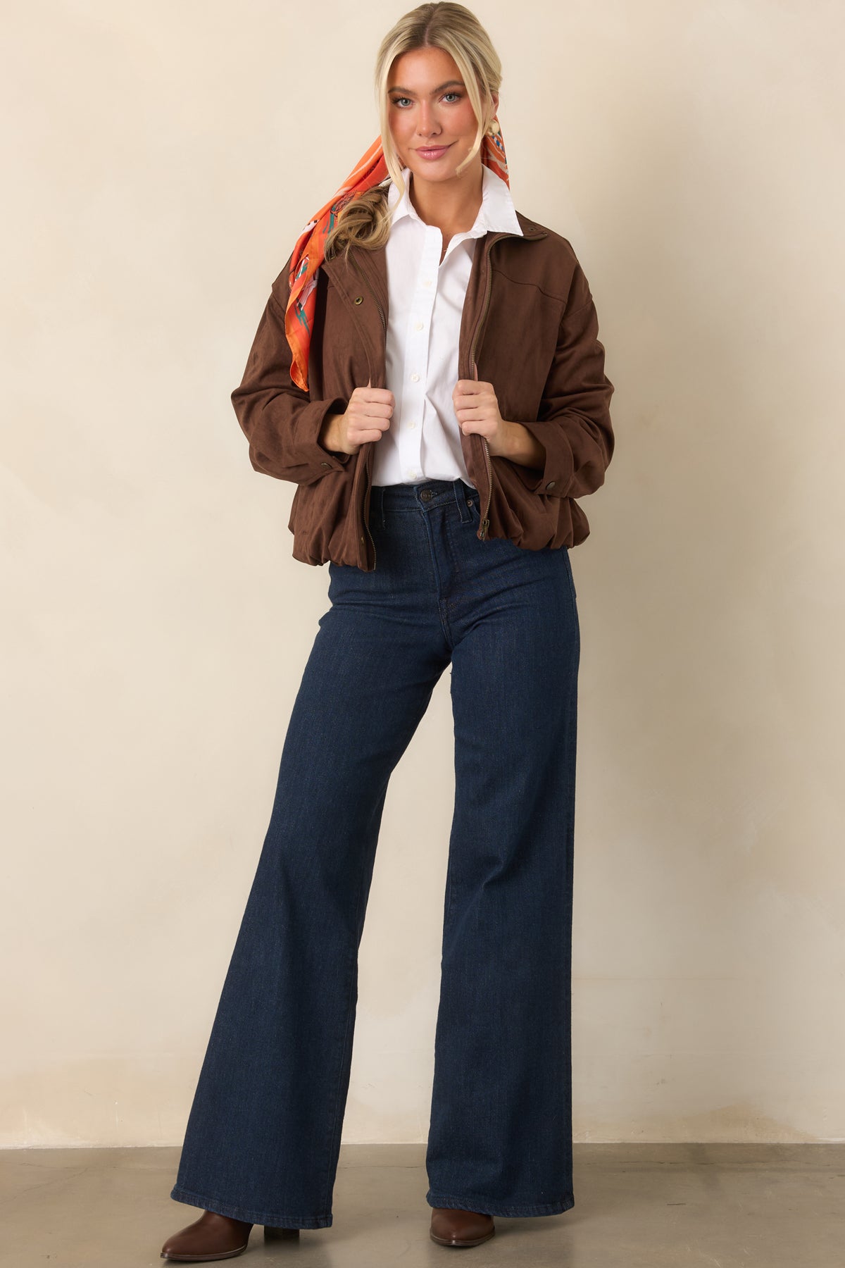 Relaxed faux suede jacket featuring a concealed front zipper, snap placket, and softly gathered bomber silhouette.