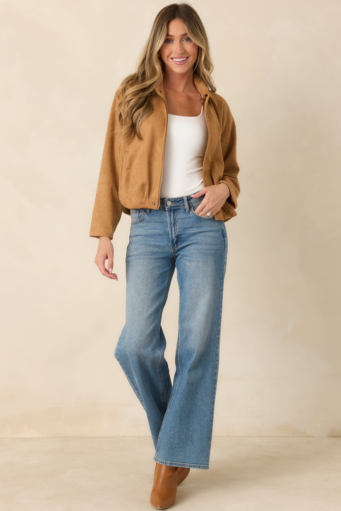 Relaxed faux suede jacket designed with dropped shoulders, a hidden zip closure, gathered hem, and streamlined seam details.