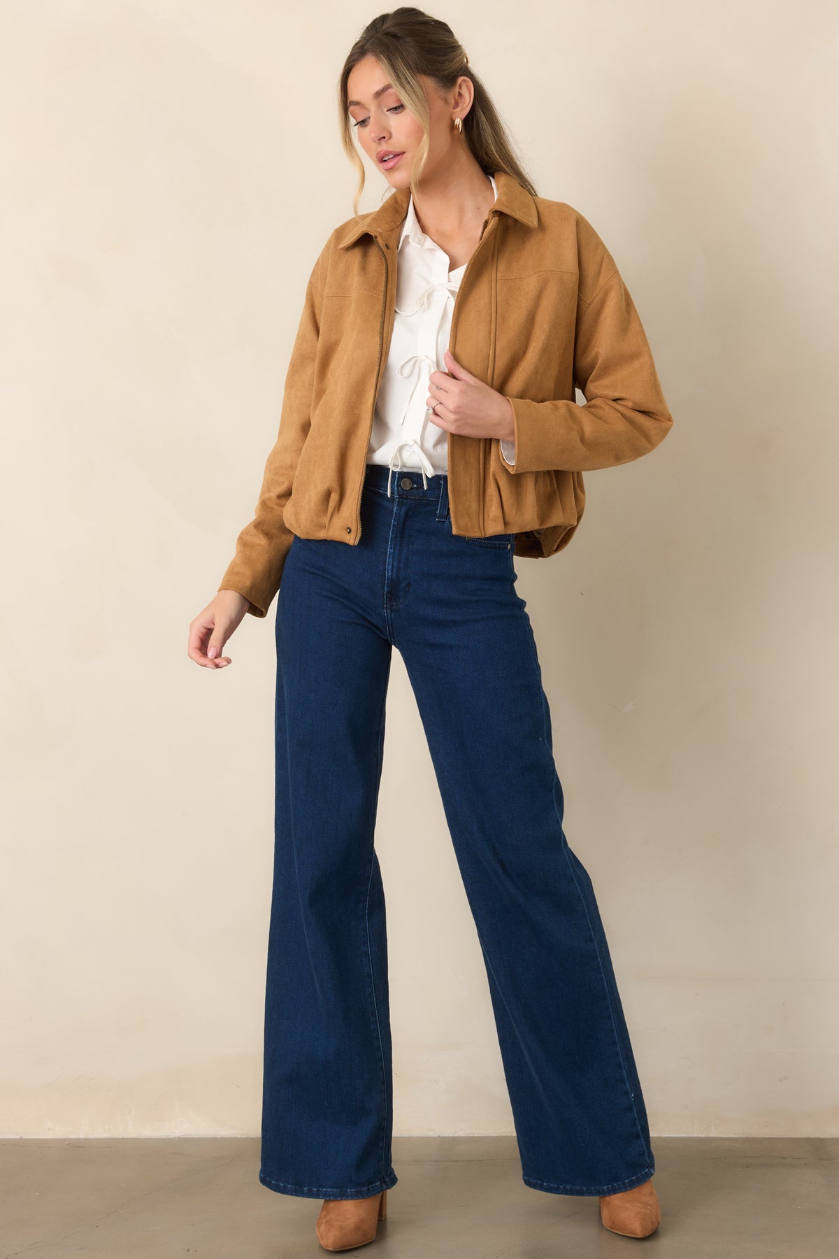 Relaxed faux suede jacket with a pointed collar, dropped shoulders, softly gathered hem, concealed zip-front closure, and clean seam detailing.