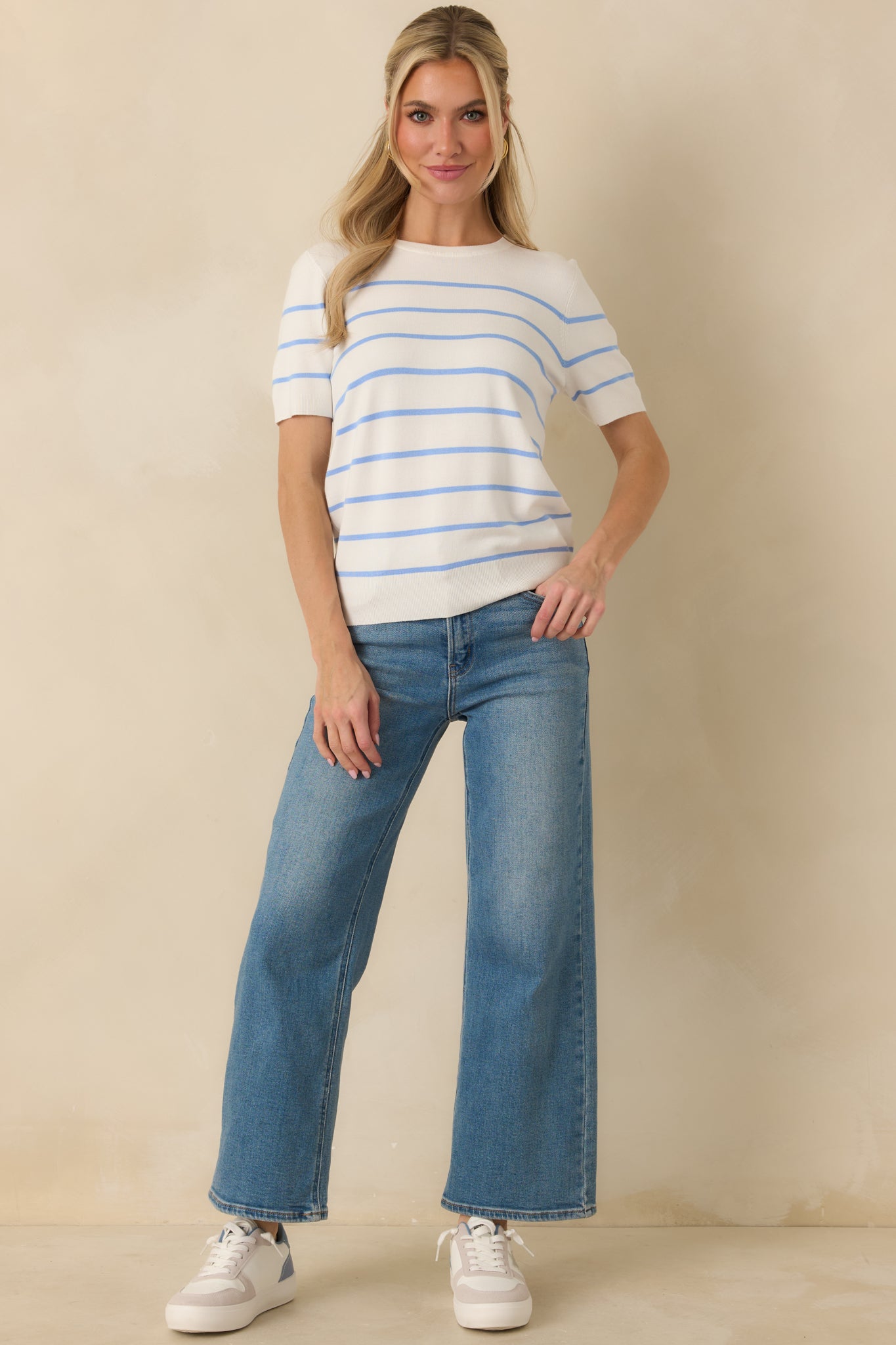 Relaxed-fit blue striped knit top with short sleeves and clean, all-season design.