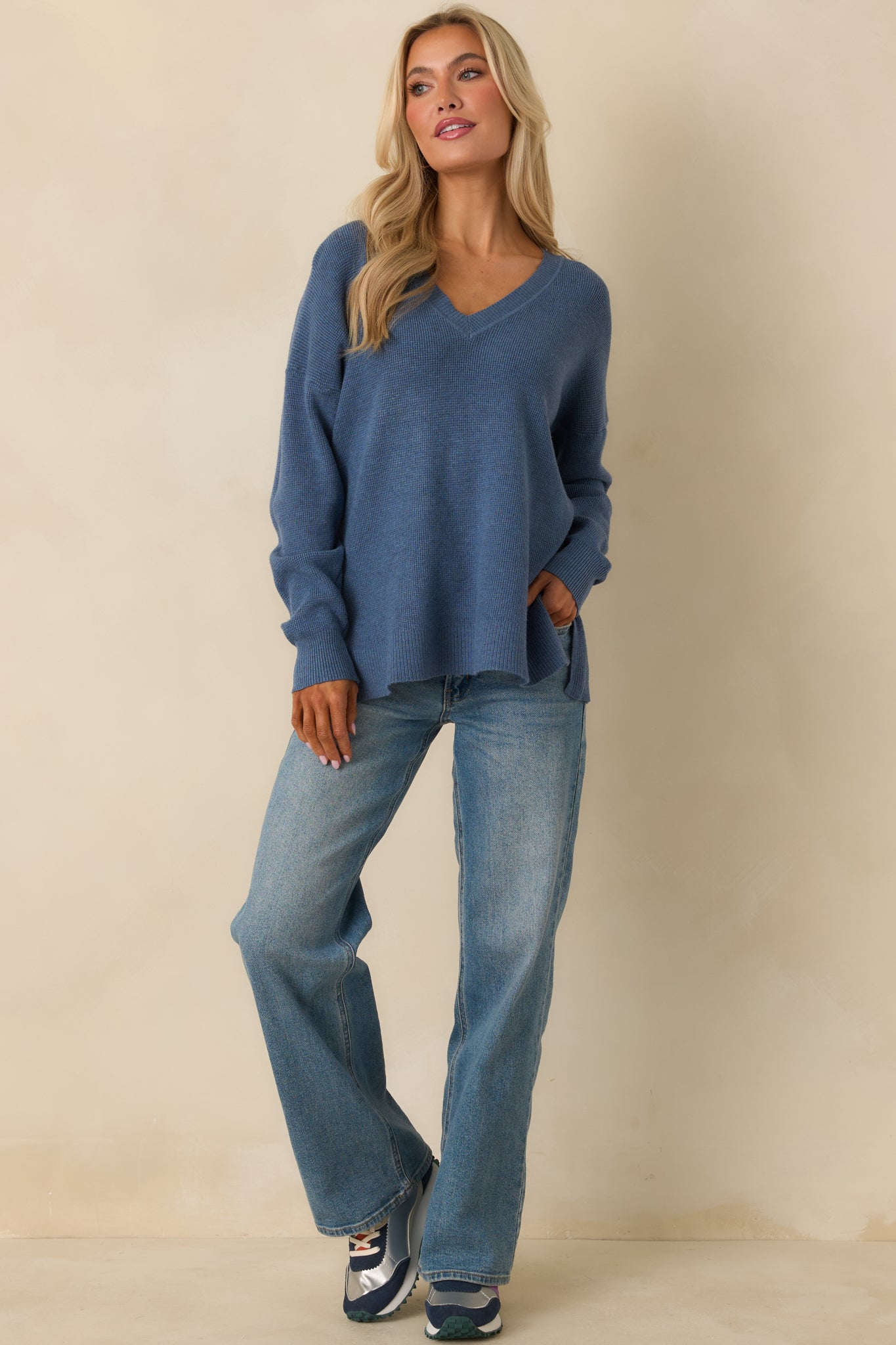 Relaxed-fit blue sweater with long sleeves and a subtly split hem for ease of movement.