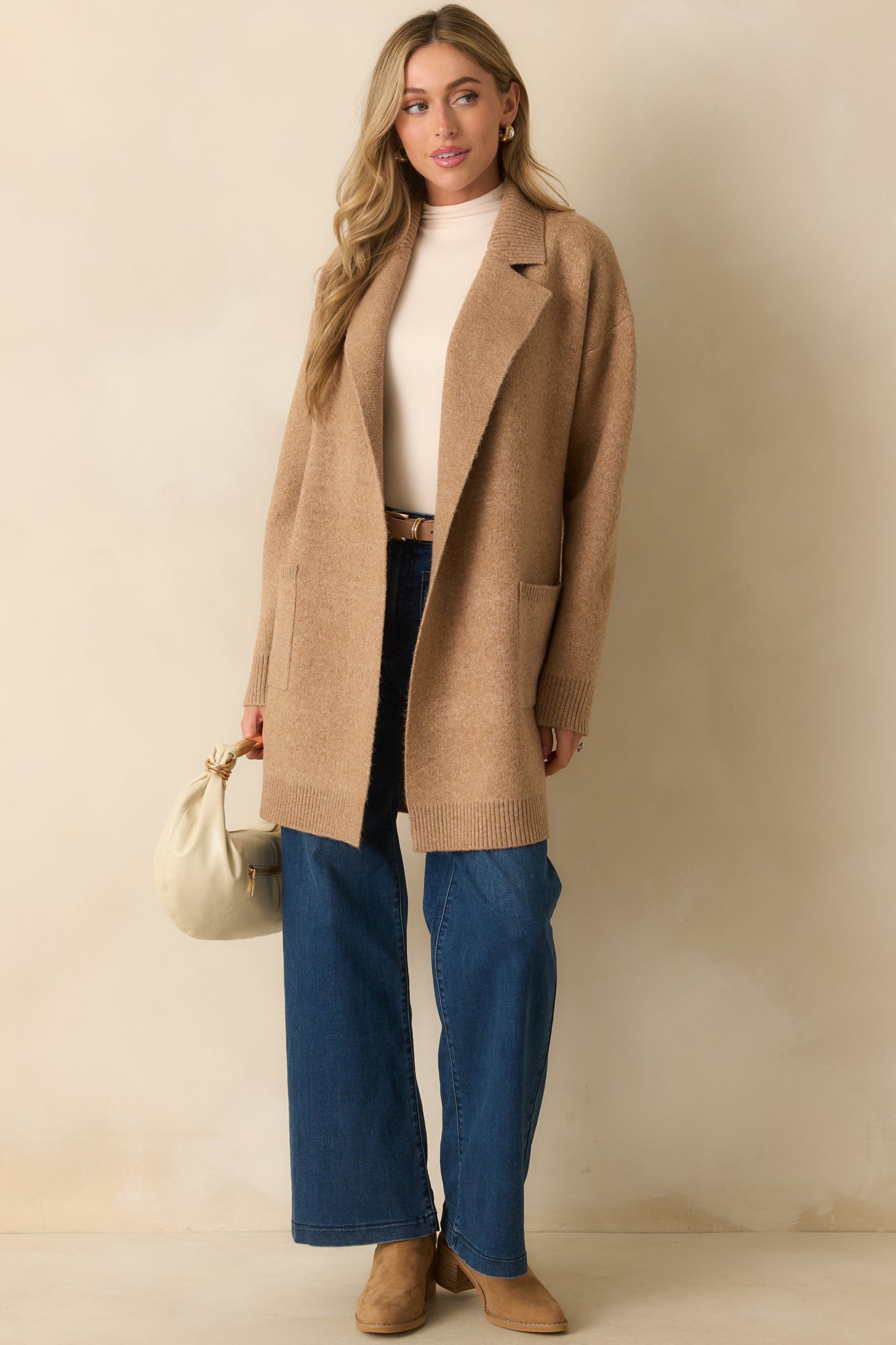 Relaxed-fit camel cardigan with ribbed hem and soft knit texture.