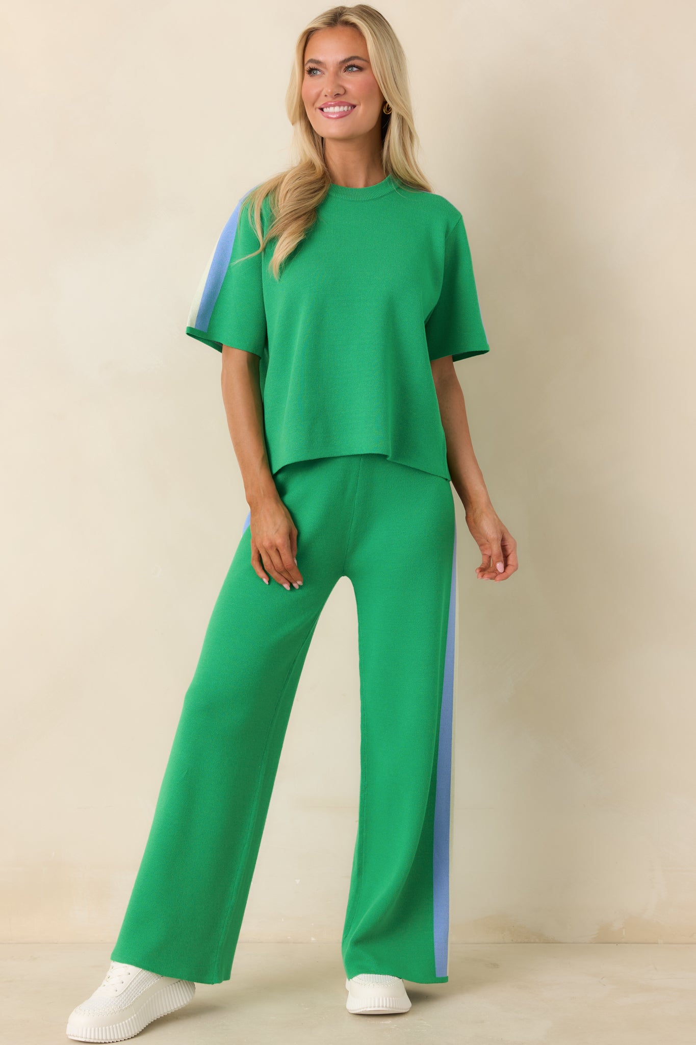 Relaxed-fit green pants featuring multi-colored stripe down the side.