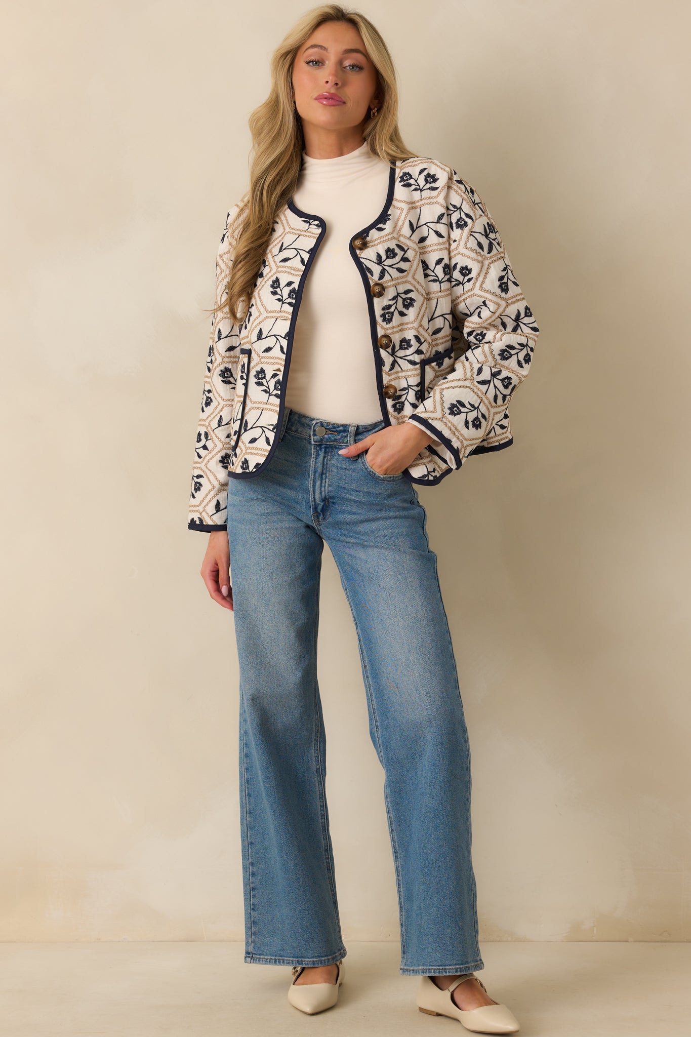 Relaxed fit jacket featuring functional front patch pockets, tortoise shell button closure, and contrast navy trim.