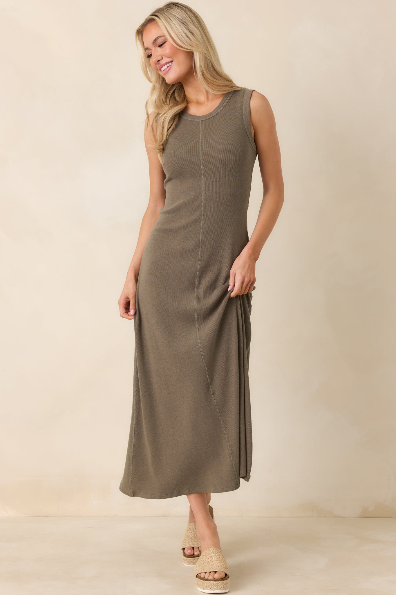 Relaxed-fit khaki green maxi dress with subtle ribbed texture and flowing full-length silhouette.