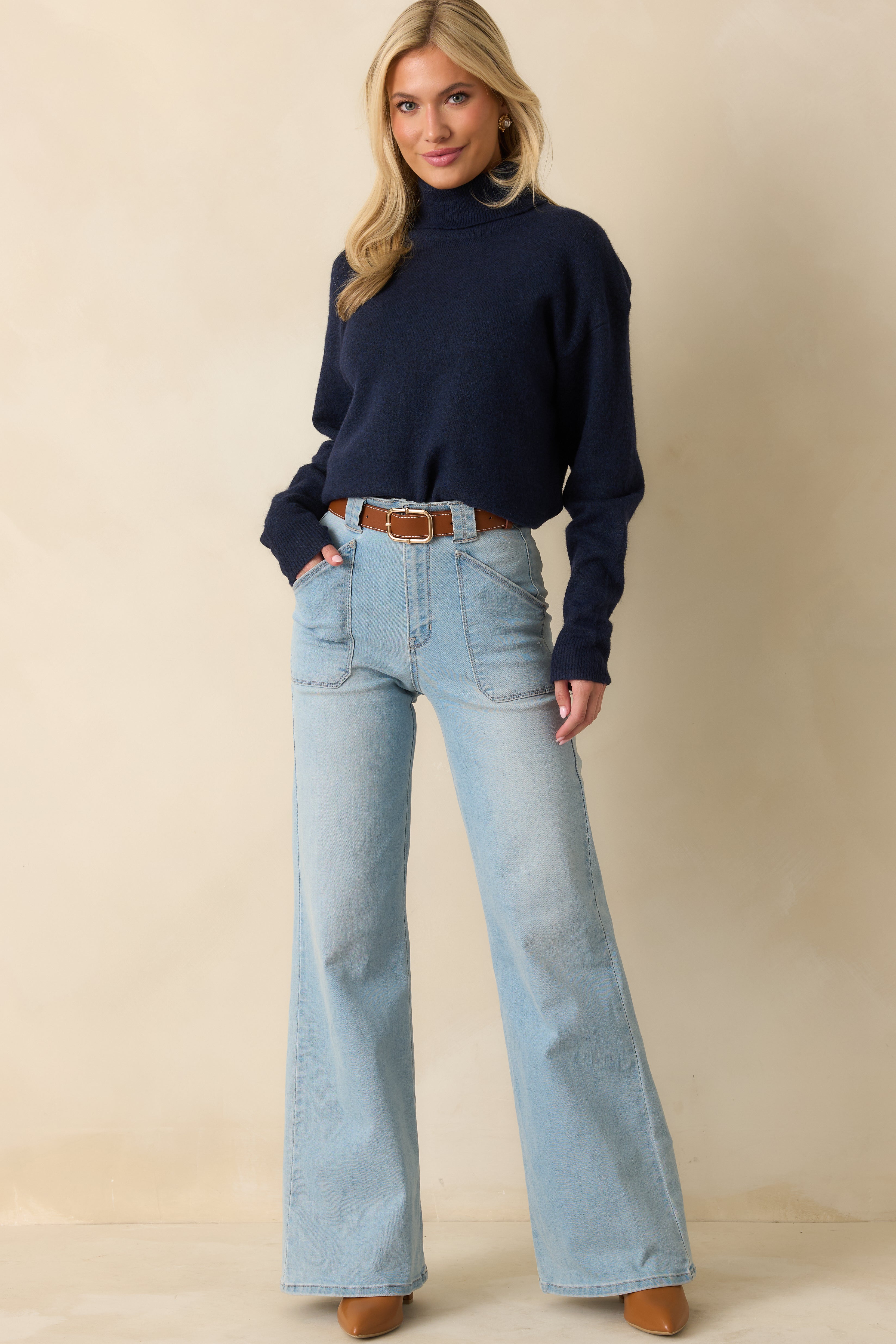 Relaxed-fit navy knit sweater with turtleneck collar and ribbed detailing at hem and cuffs.