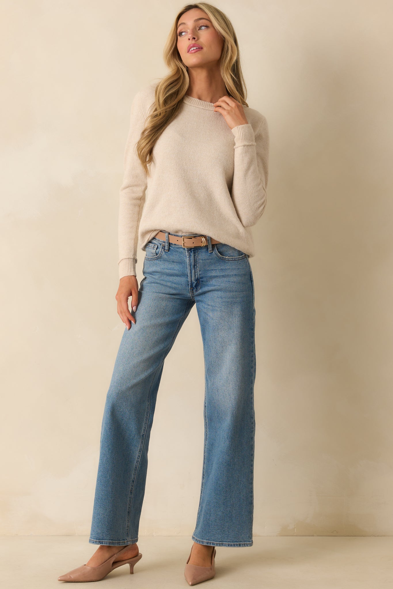 Relaxed fit sweater with ribbed edges and smooth oatmeal beige fabric.