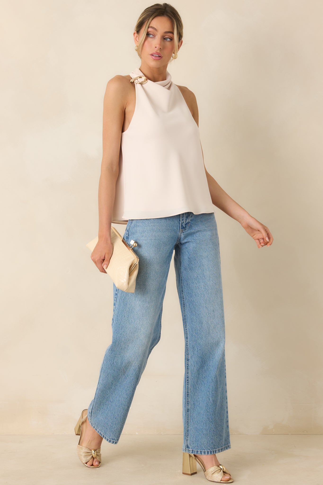 Relaxed fit top in light beige with elegant draped neckline and accent hardware.